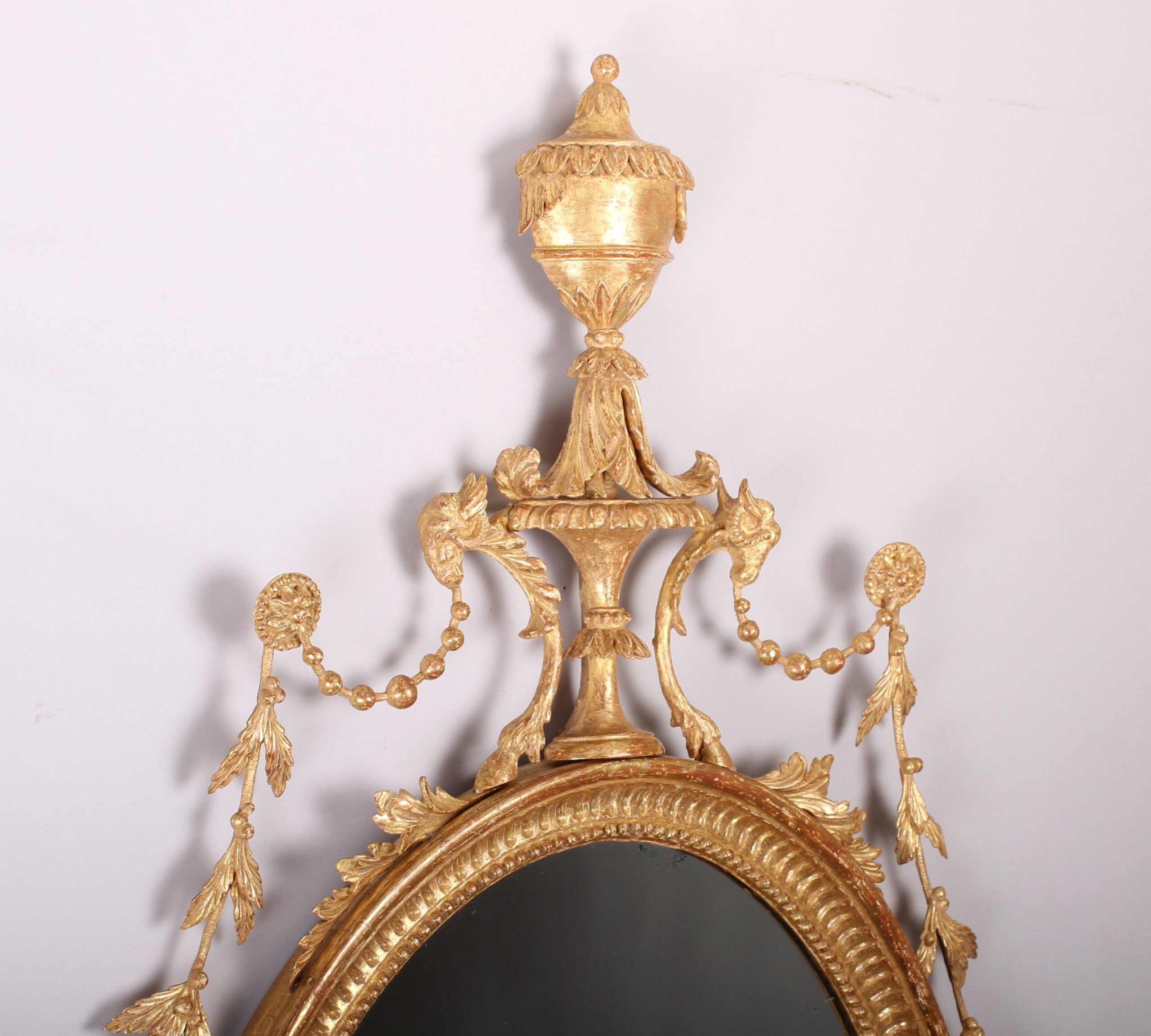 A fine quality and decorative carved and gilt mirror in the neo-classical style
