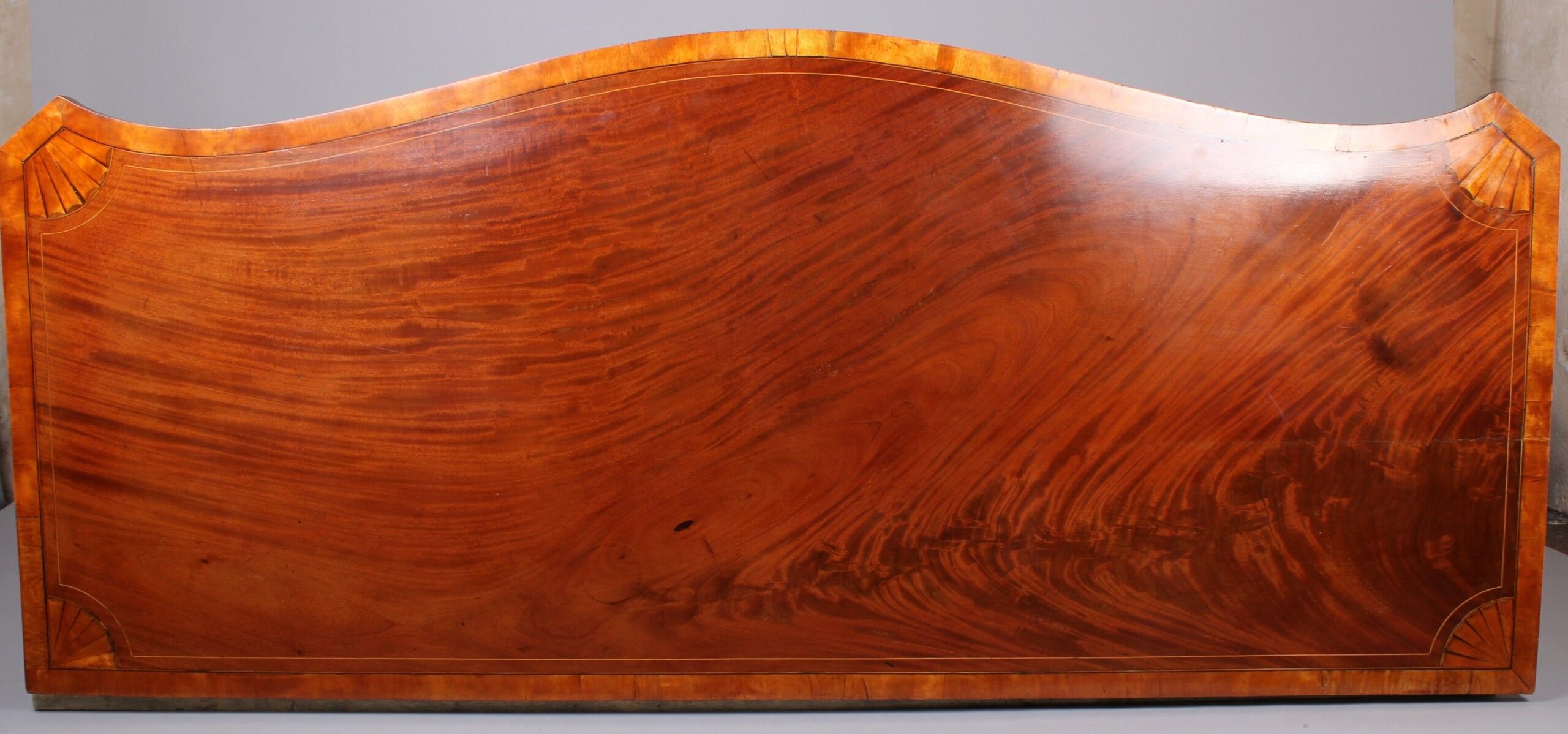 George III period mahogany and satinwood banded serpentine-fronted sideboard