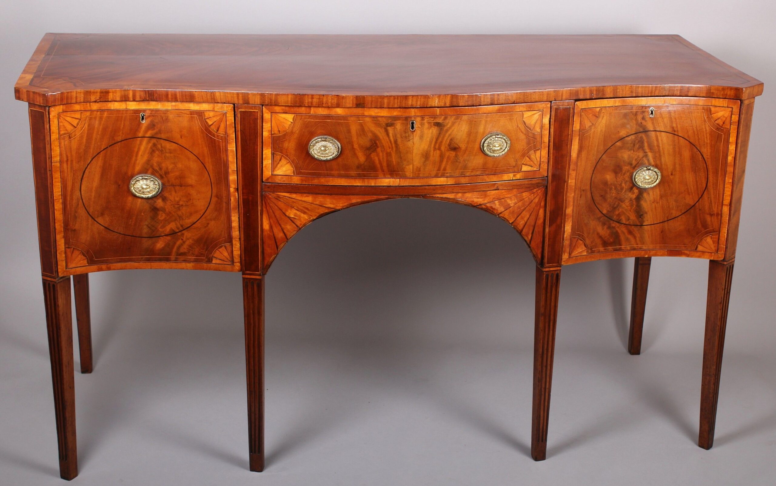 George III period mahogany and satinwood banded serpentine-fronted sideboard