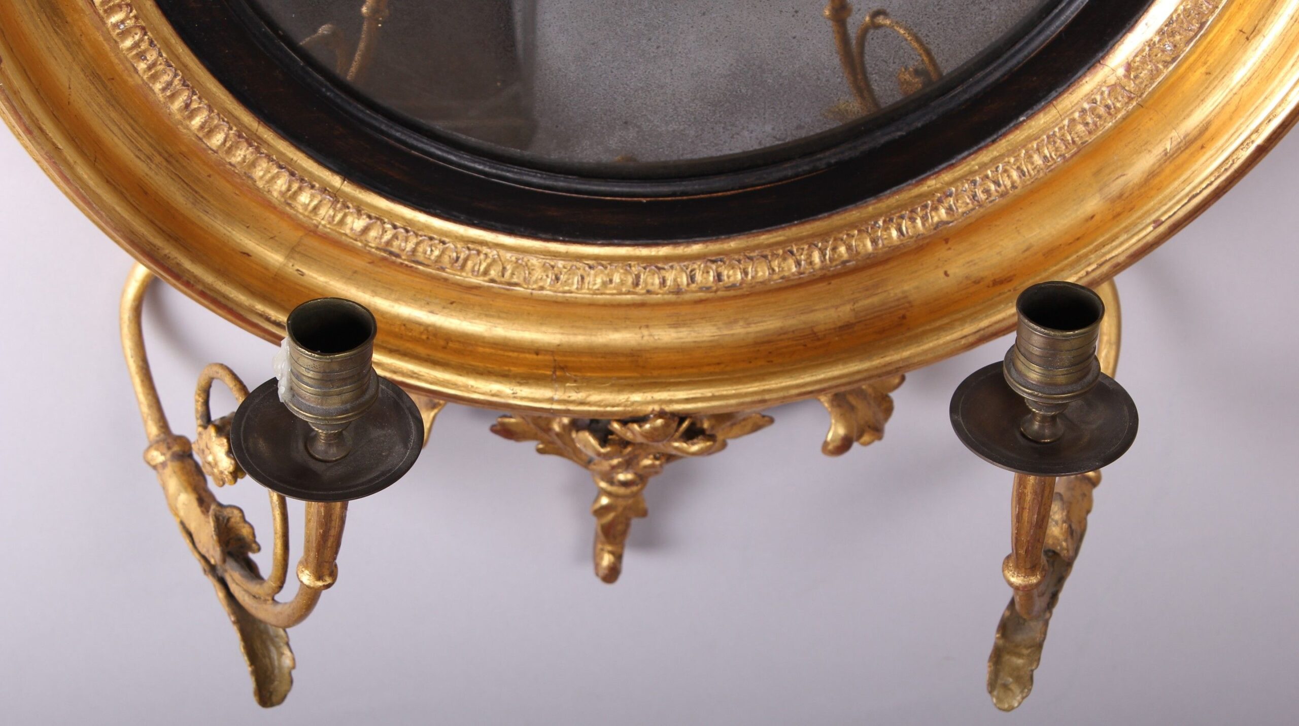 Regency gilt wood convex girandole mirror of small proportions