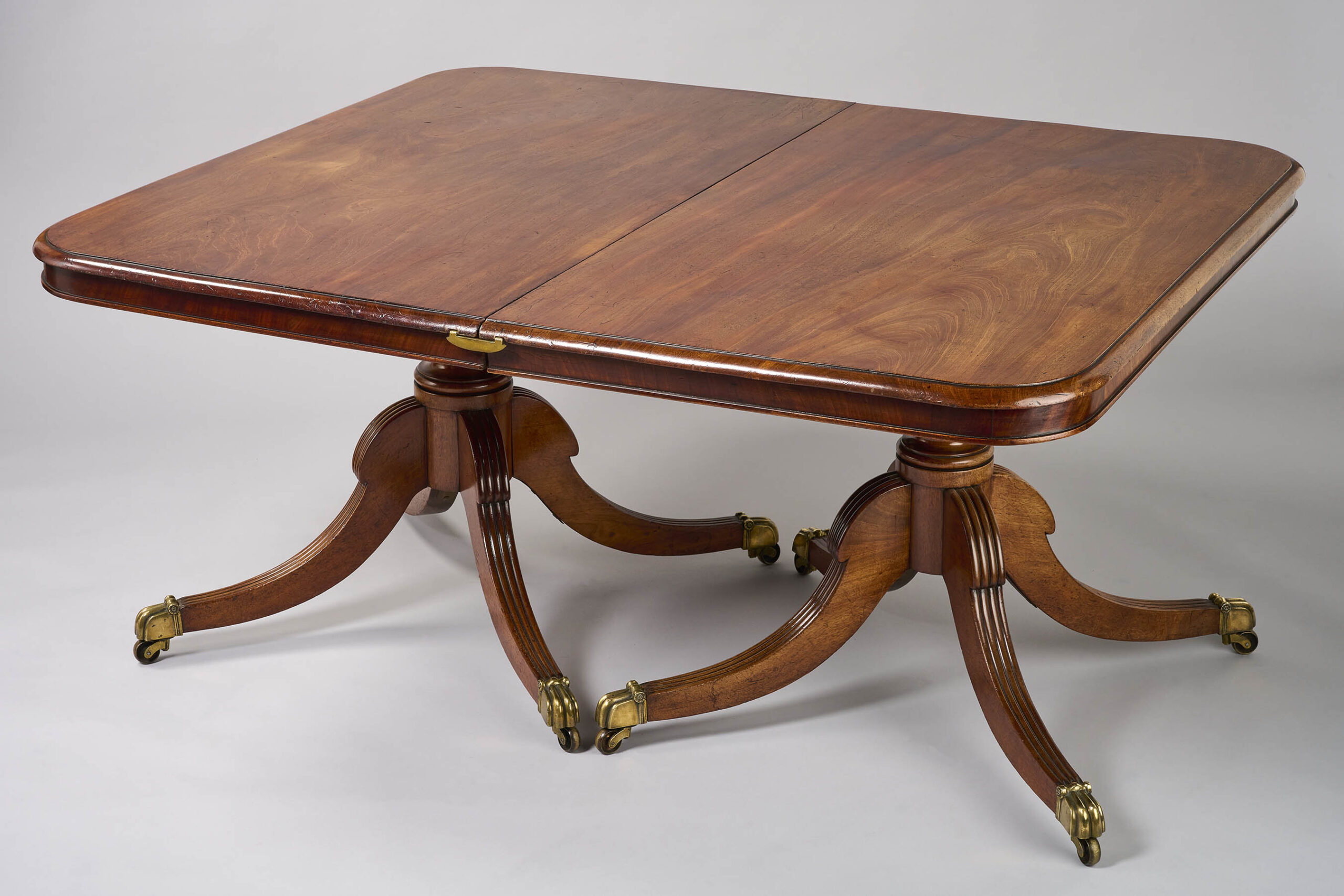 A George III period mahogany twin pillar dining table