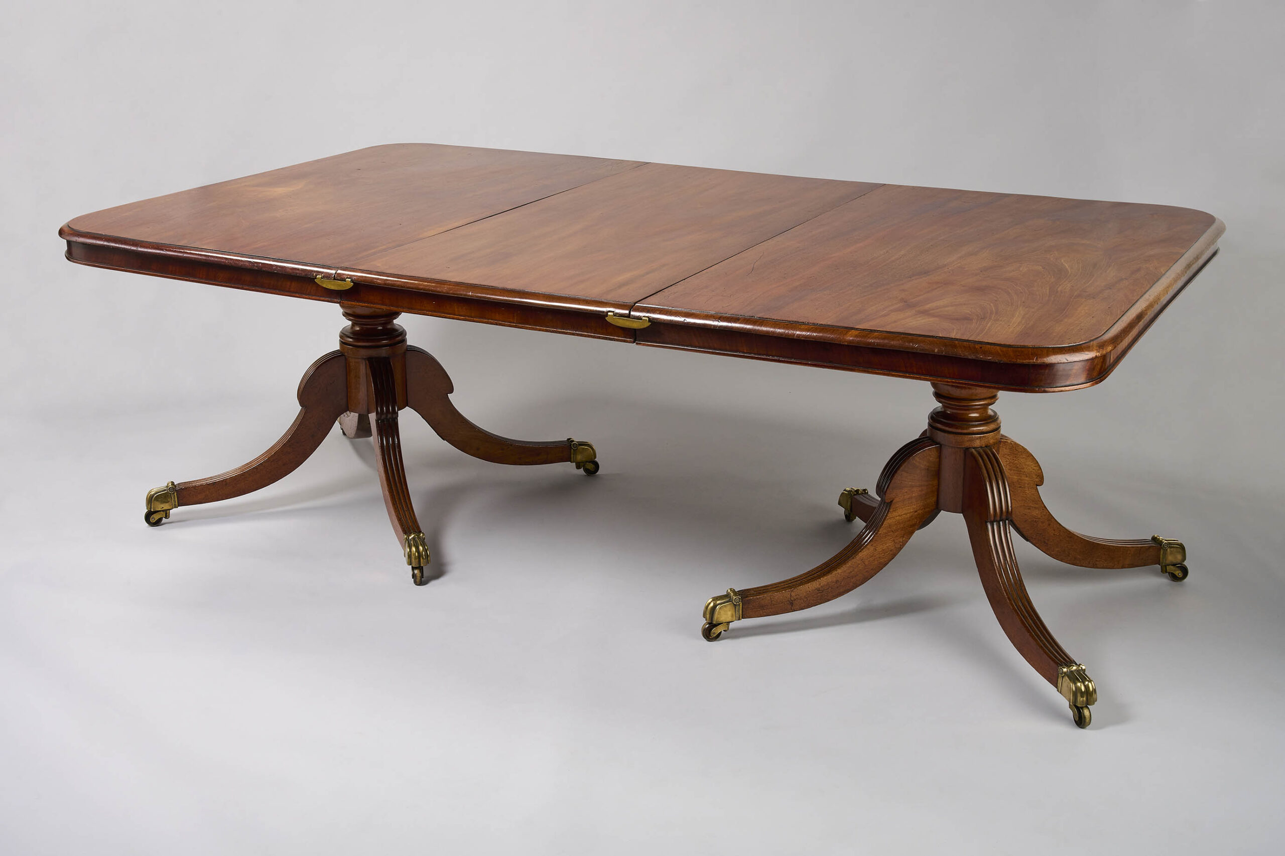 A George III period mahogany twin pillar dining table
