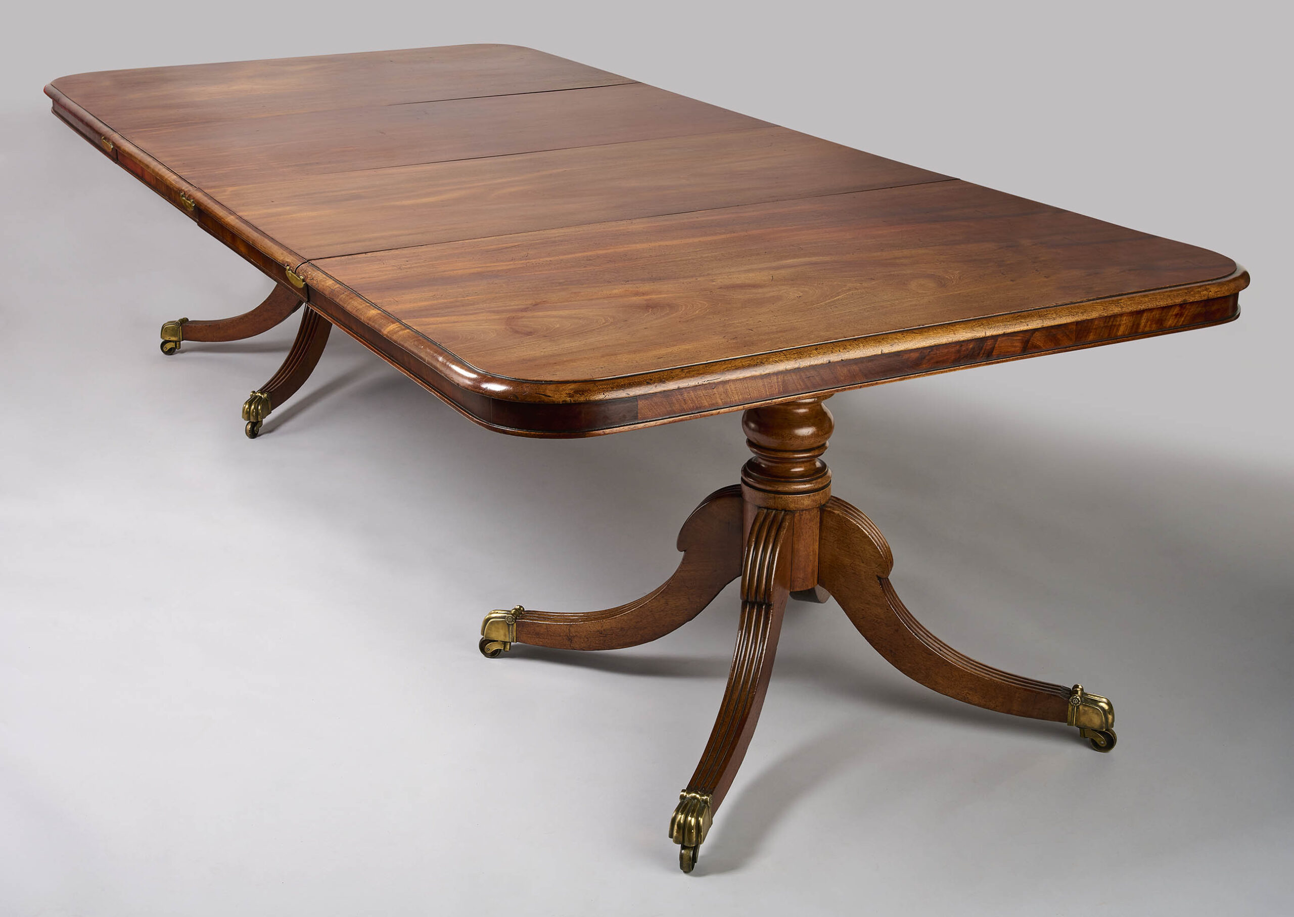 A George III period mahogany twin pillar dining table