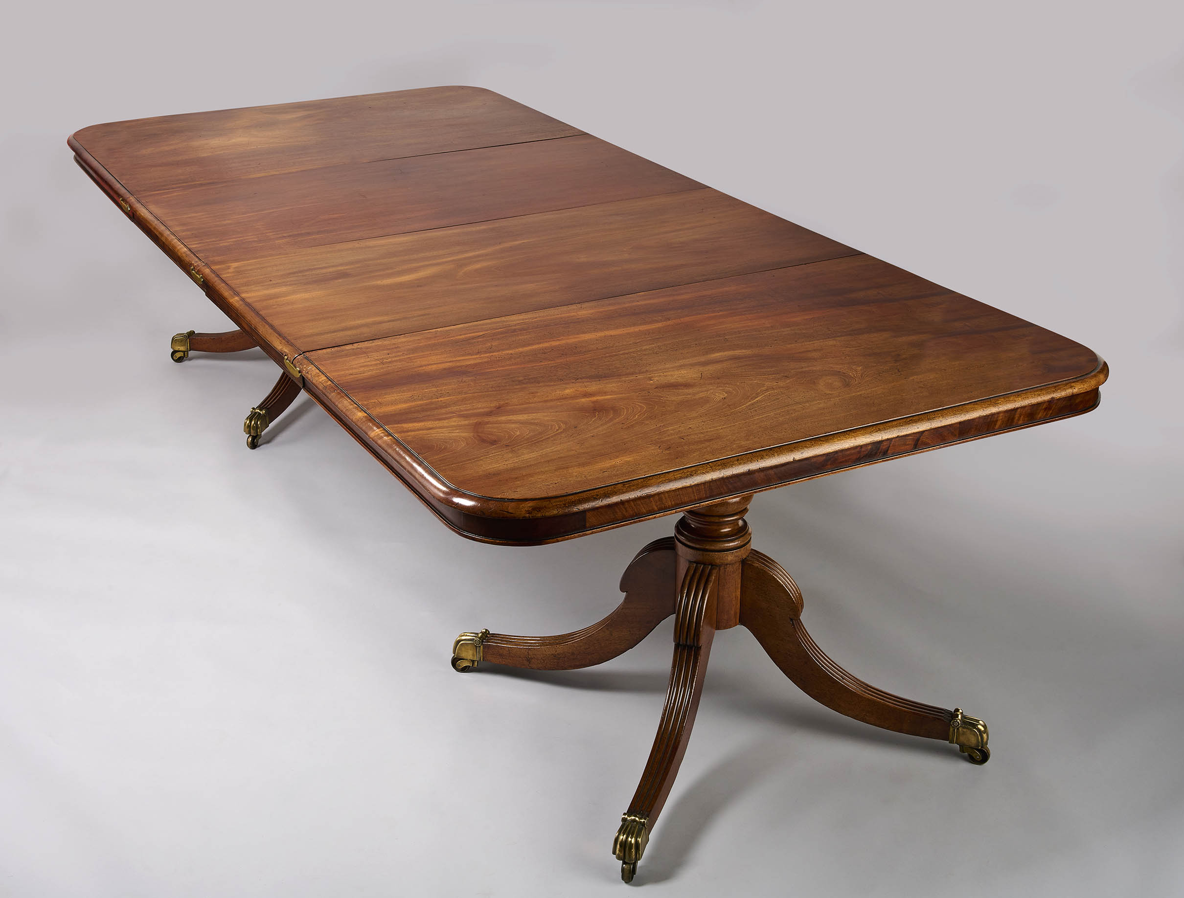 A George III period mahogany twin pillar dining table