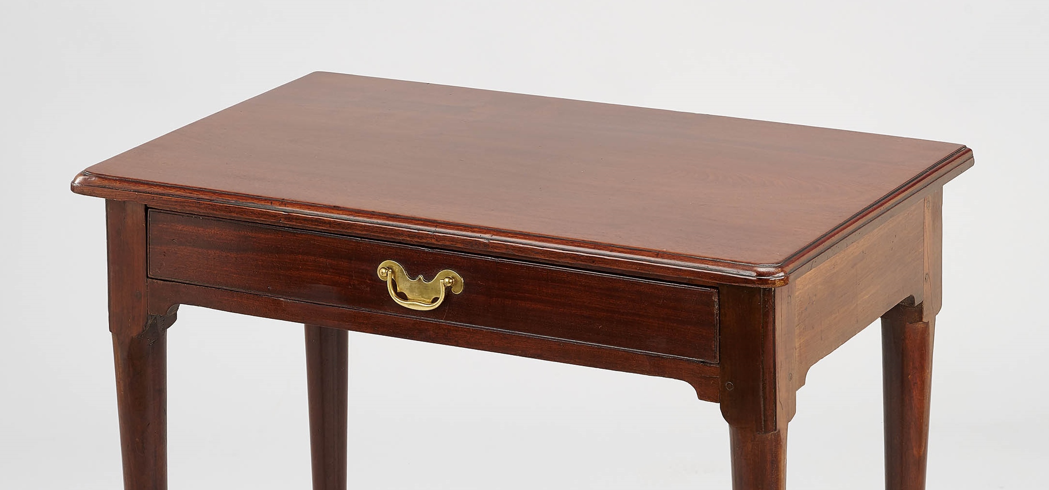 A matched pair of George II period ‘red walnut’ side-tables