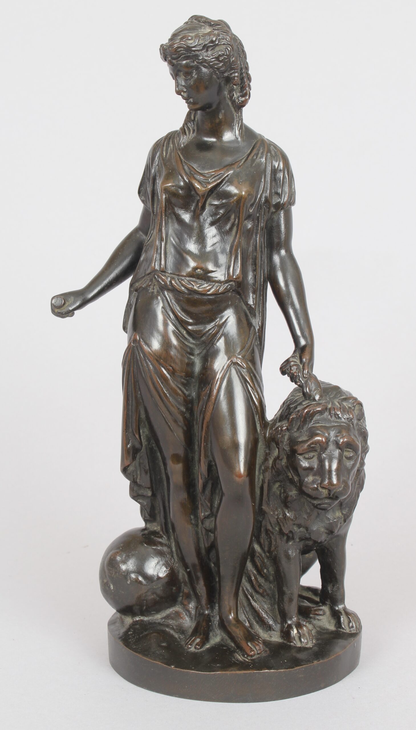 Bronze statuette of a classical woman and lion