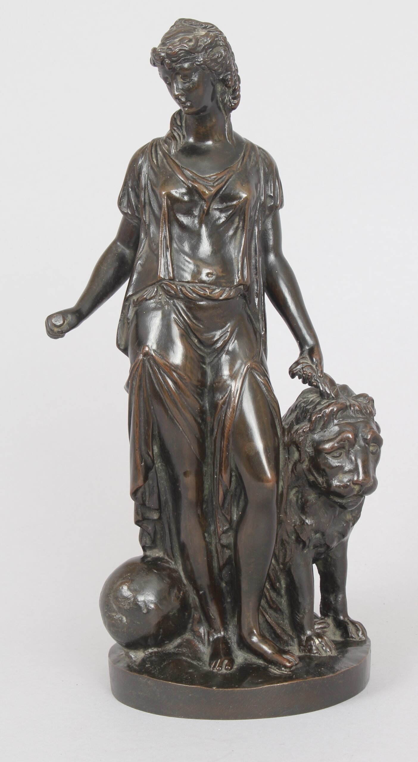 Bronze statuette of a classical woman and lion
