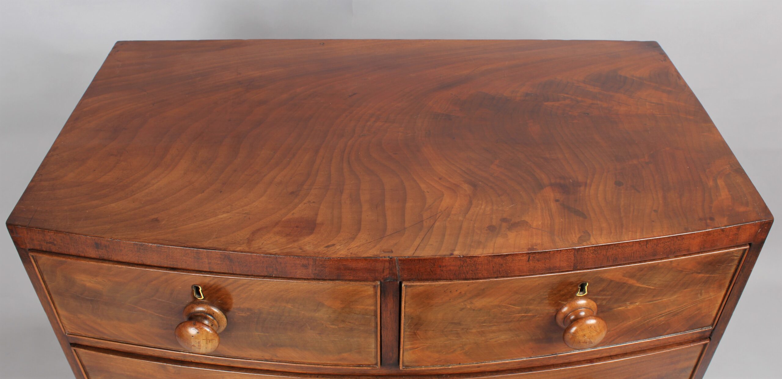 A small early Victorian bow-fronted mahogany chest of drawers