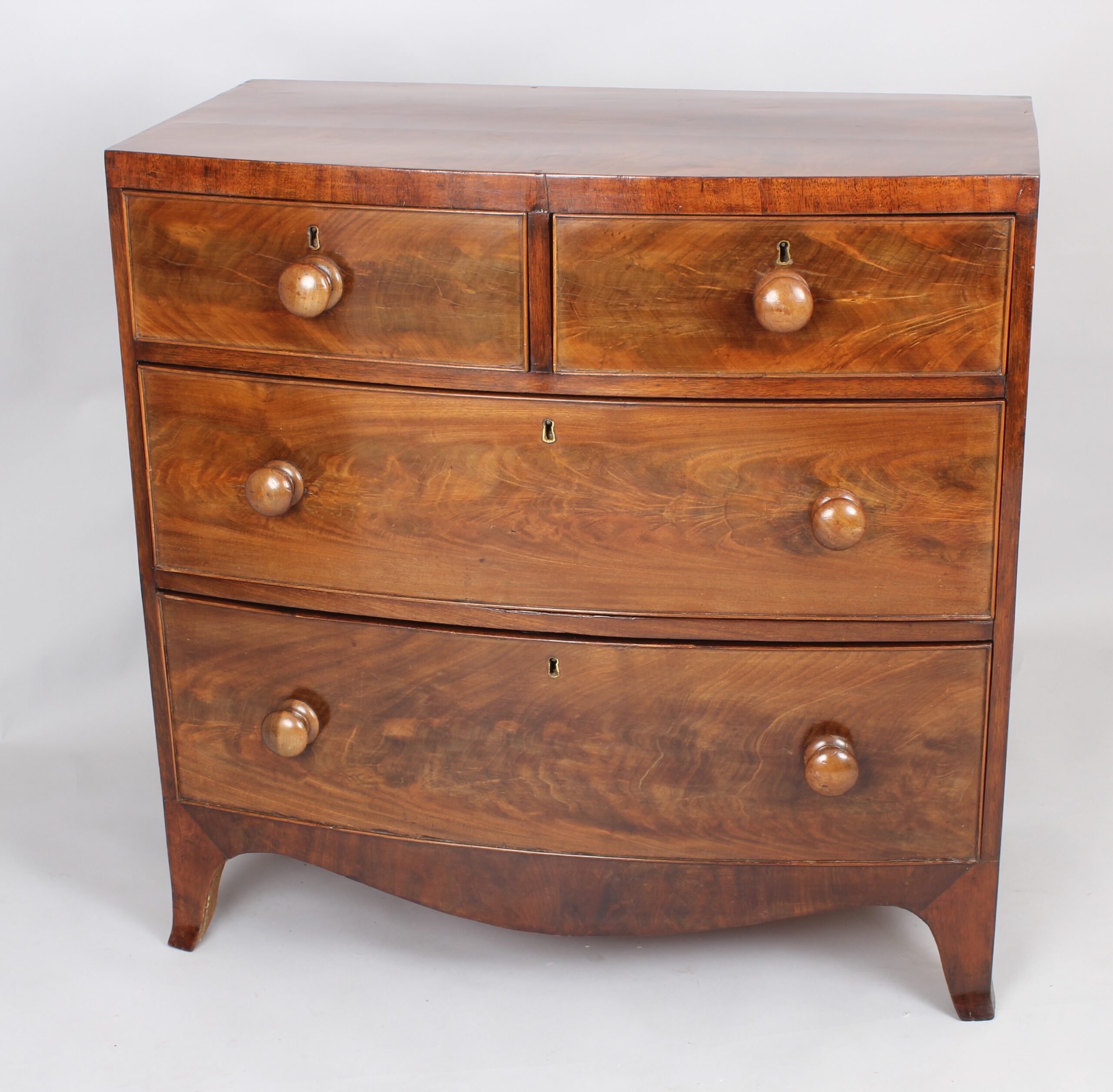 A small early Victorian bow-fronted mahogany chest of drawers