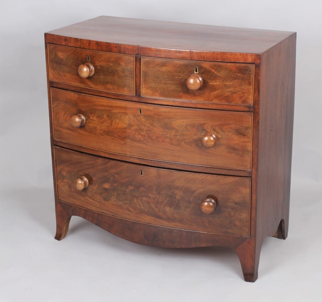A small early Victorian bow-fronted mahogany chest of drawers