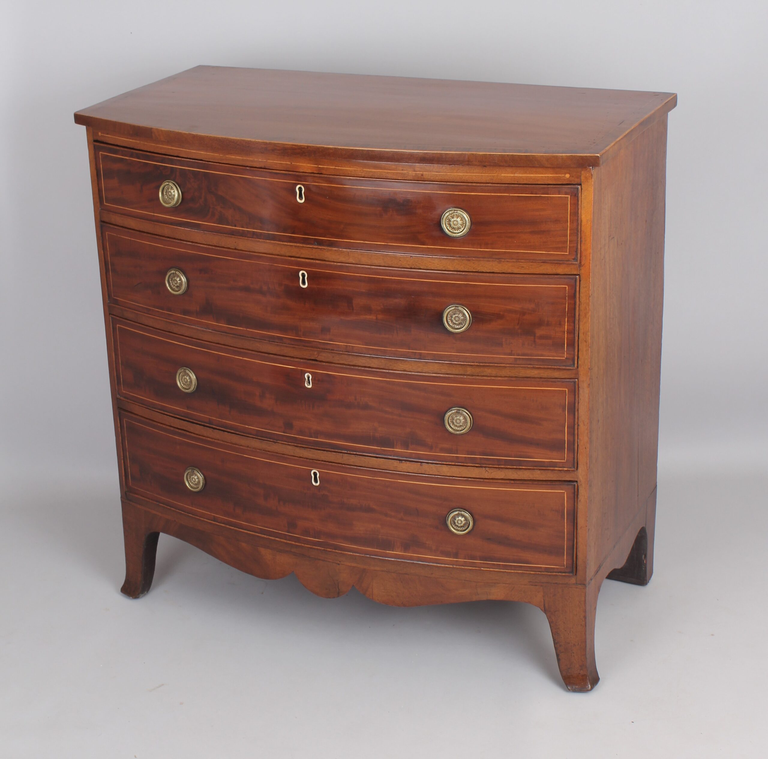 Mahogany bow-fronted chest of four graduated drawers