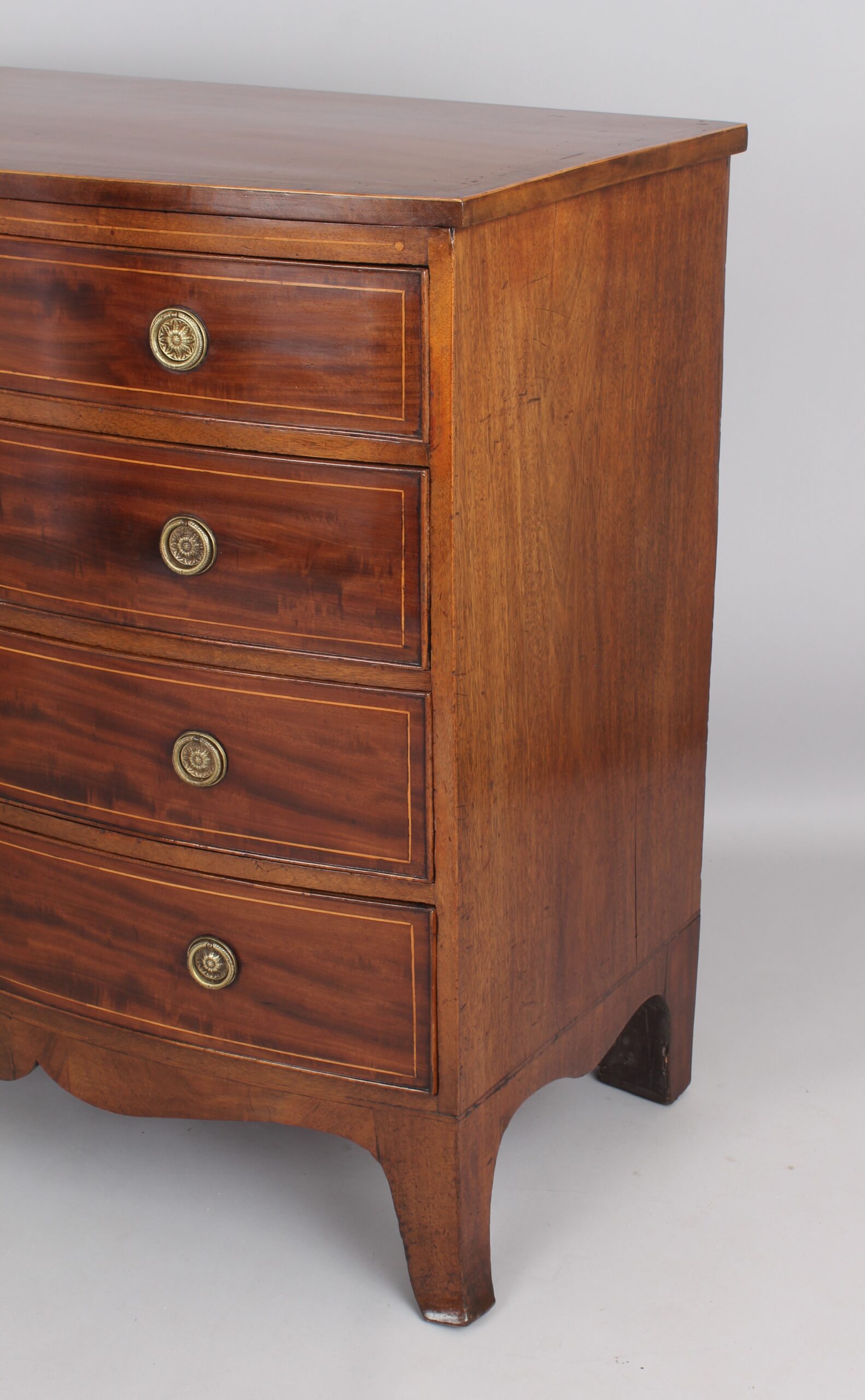 Mahogany bow-fronted chest of four graduated drawers