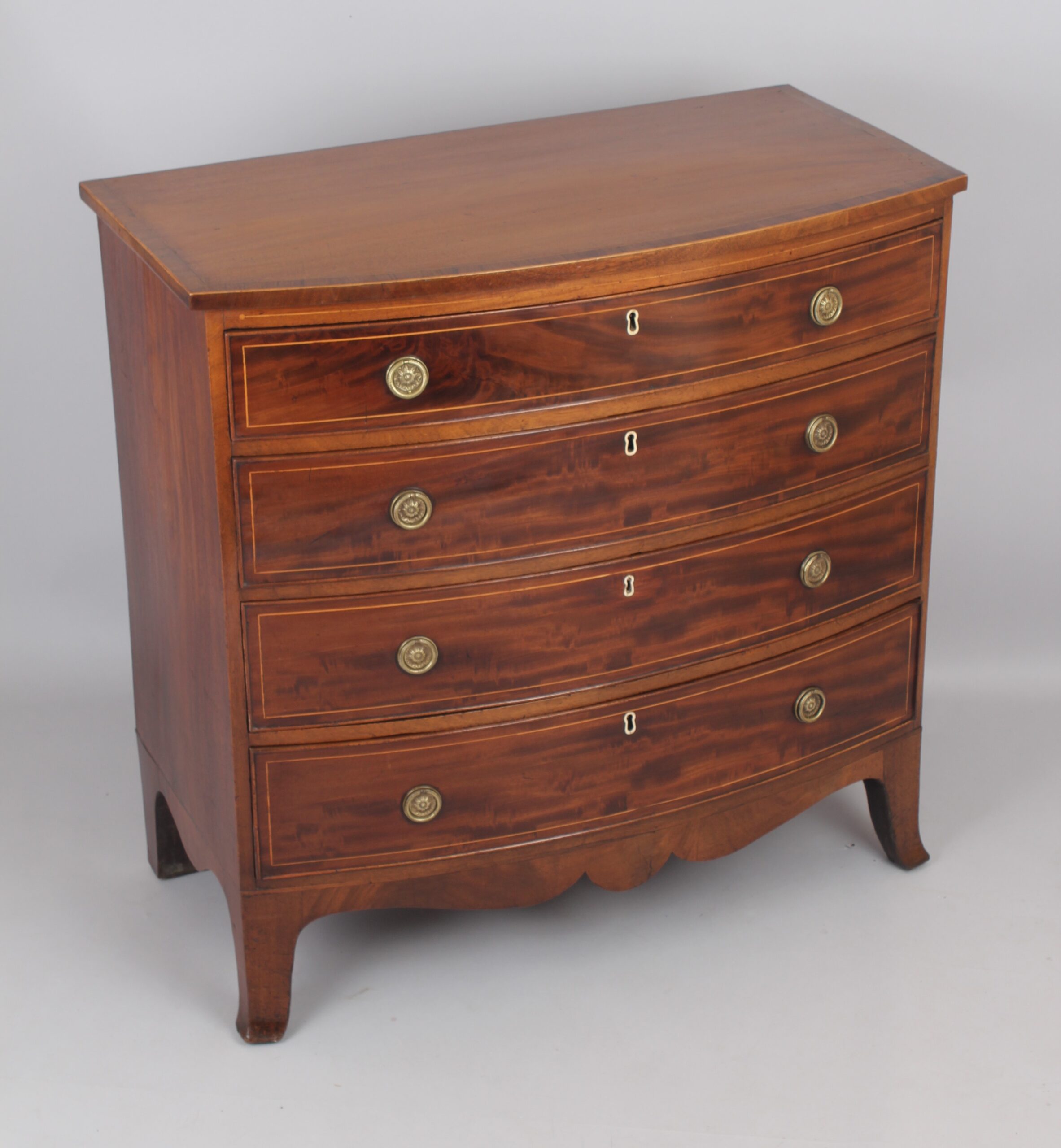 Mahogany bow-fronted chest of four graduated drawers