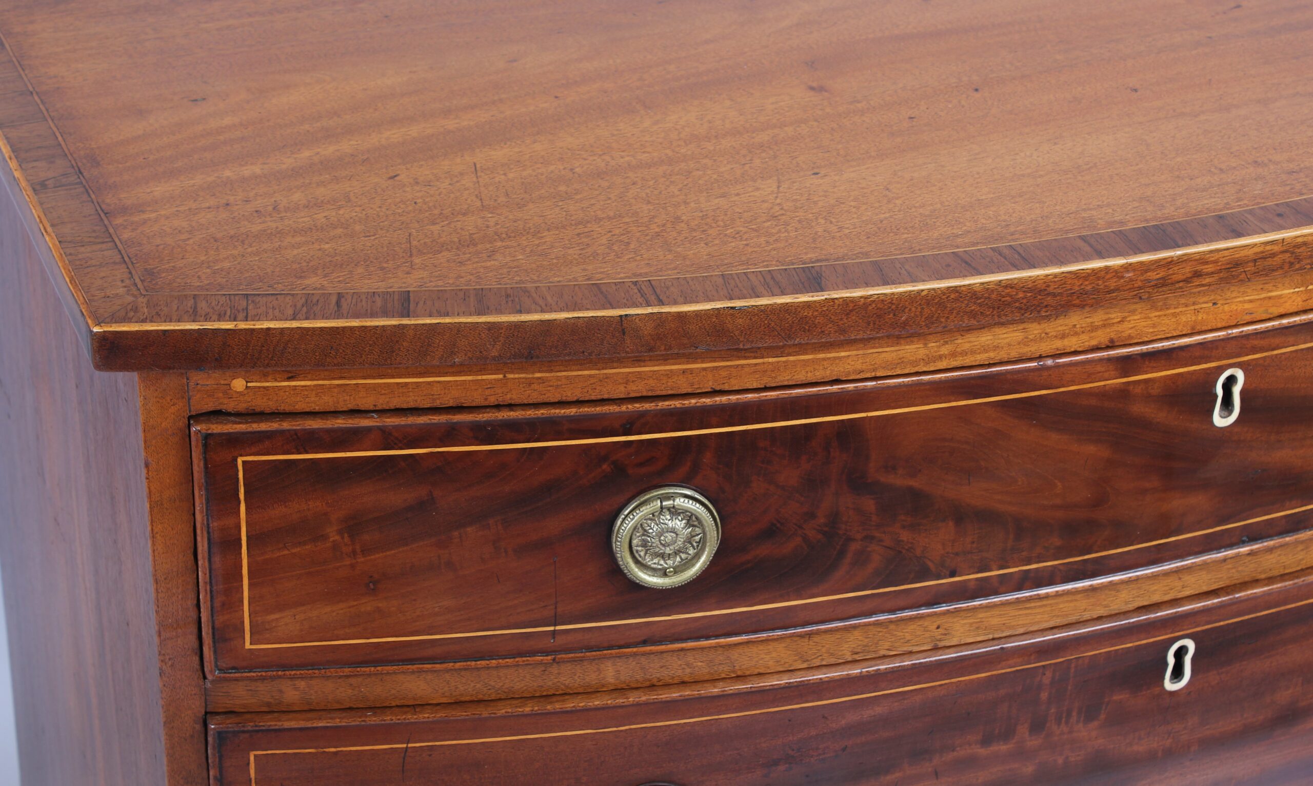 Mahogany bow-fronted chest of four graduated drawers