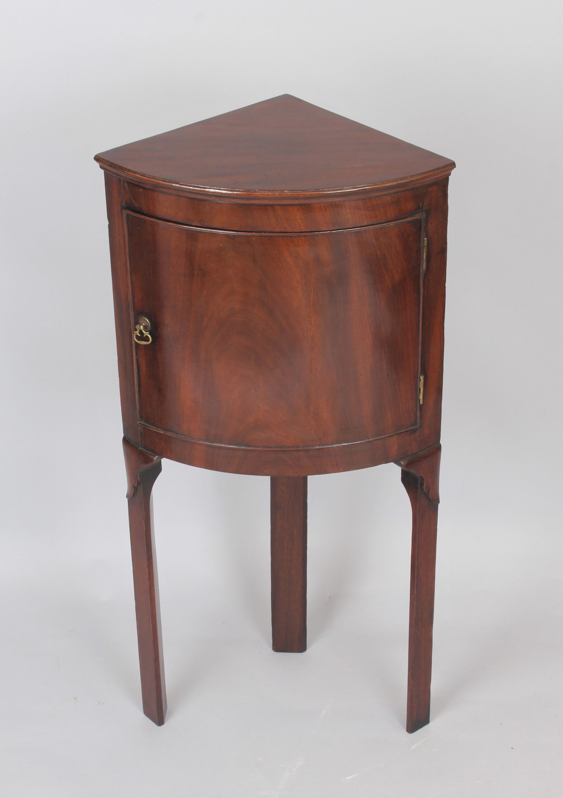 George III period mahogany bow-fronted corner cupboard