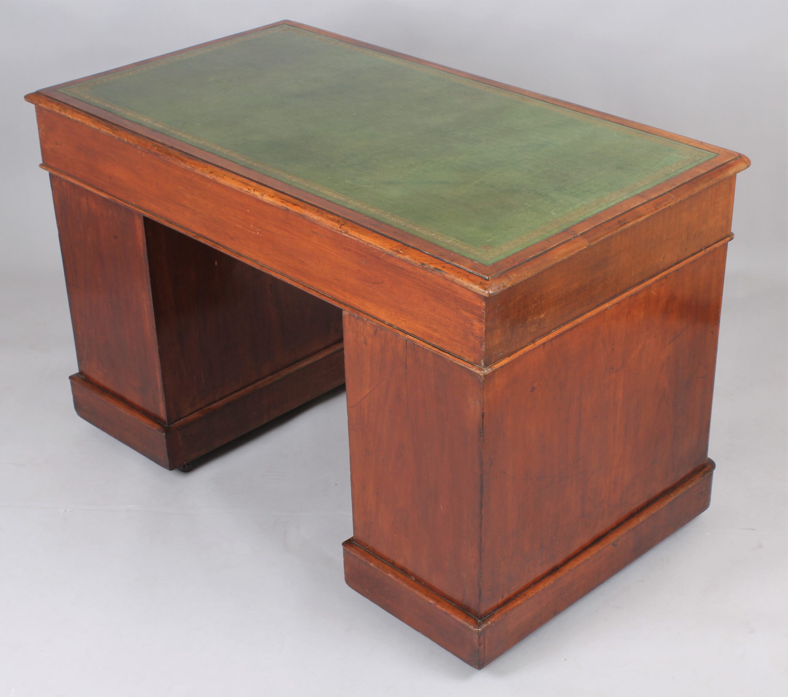 A mahogany three-part pedestal desk