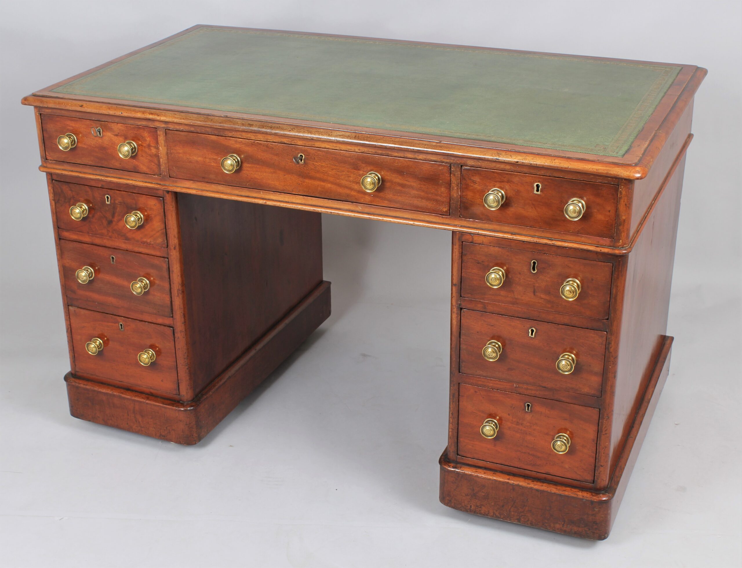 A mahogany three-part pedestal desk