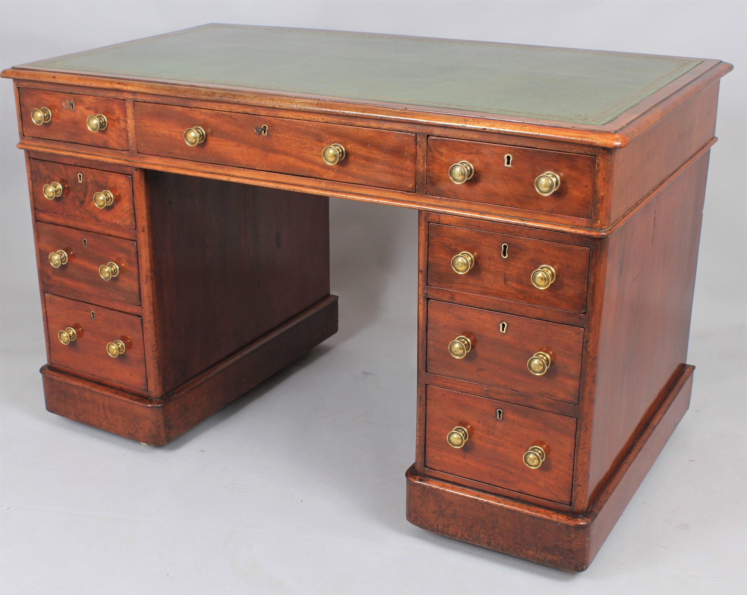 A mahogany three-part pedestal desk