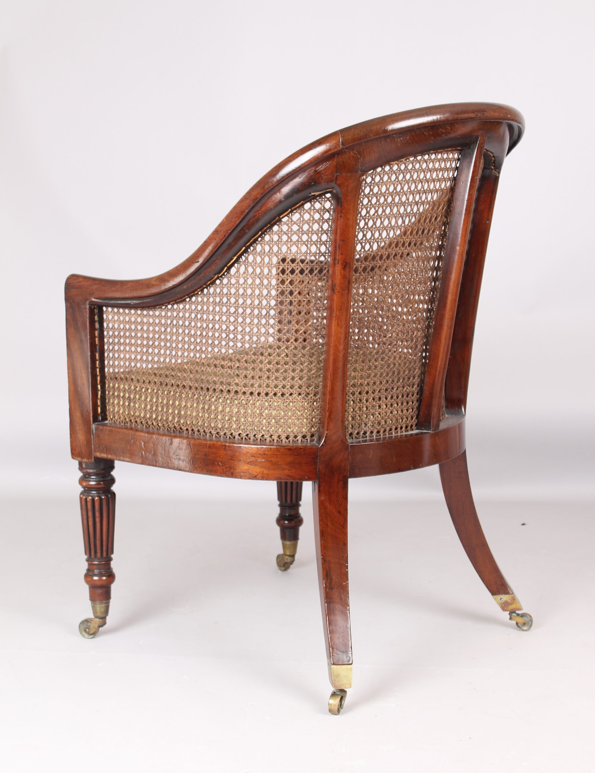 An early 19th century mahogany bergere chair
