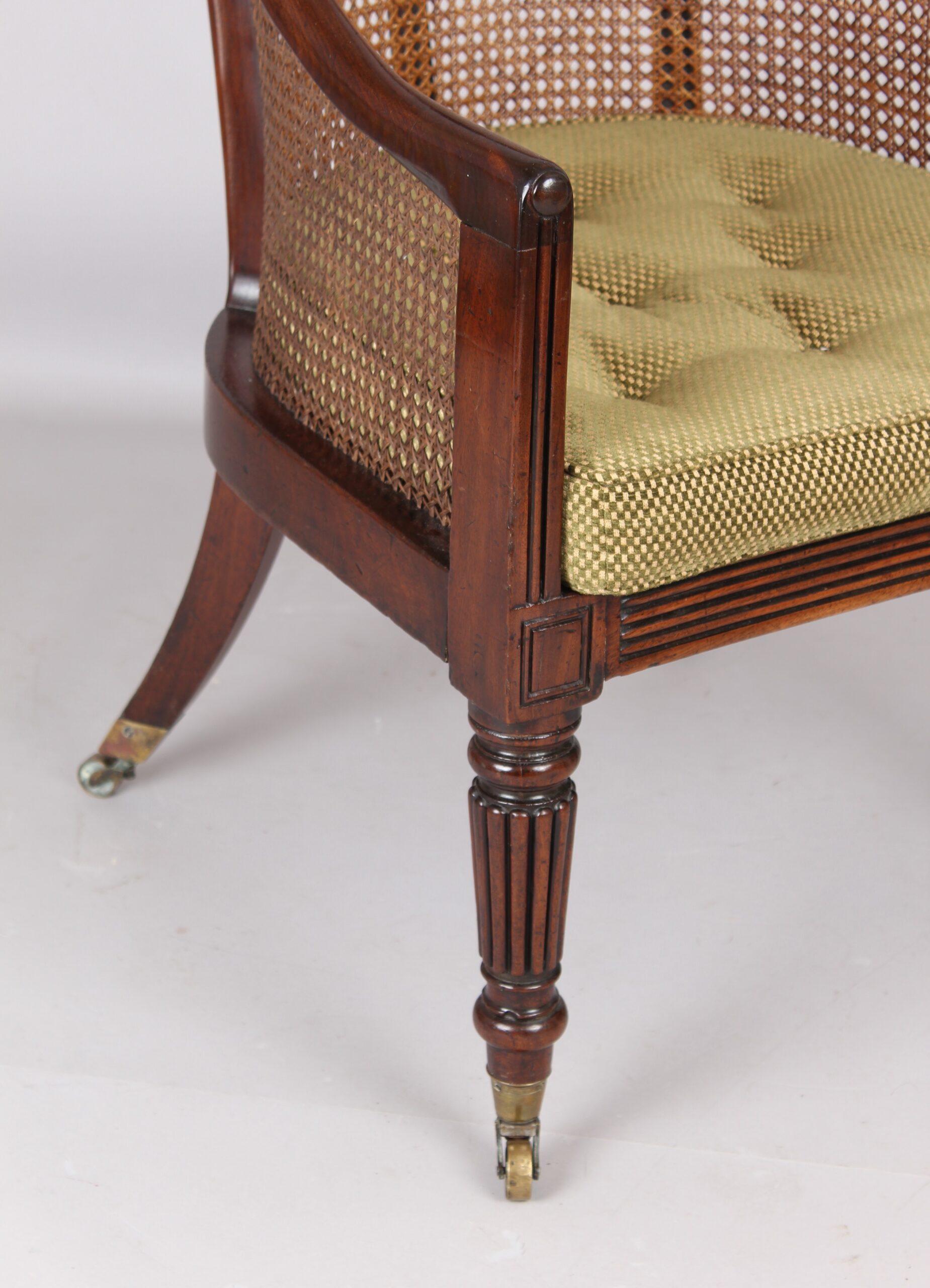 An early 19th century mahogany bergere chair