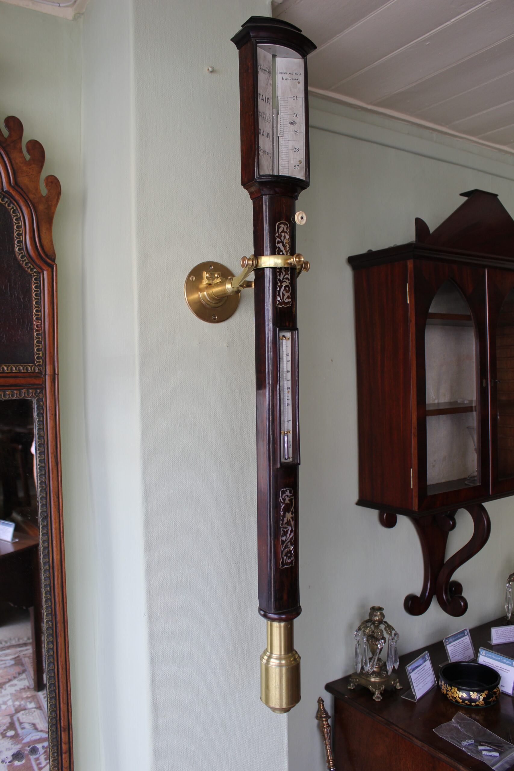 A bow-fronted marine barometer in a well-figured rosewood case