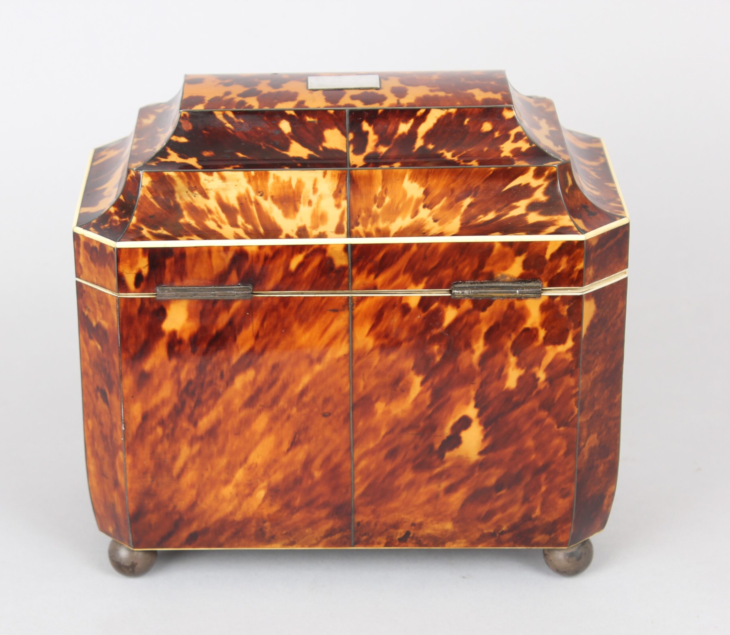 A fine WIV period casket shaped well figured tortoiseshell and engraved mother of pearl inlaid tea caddy