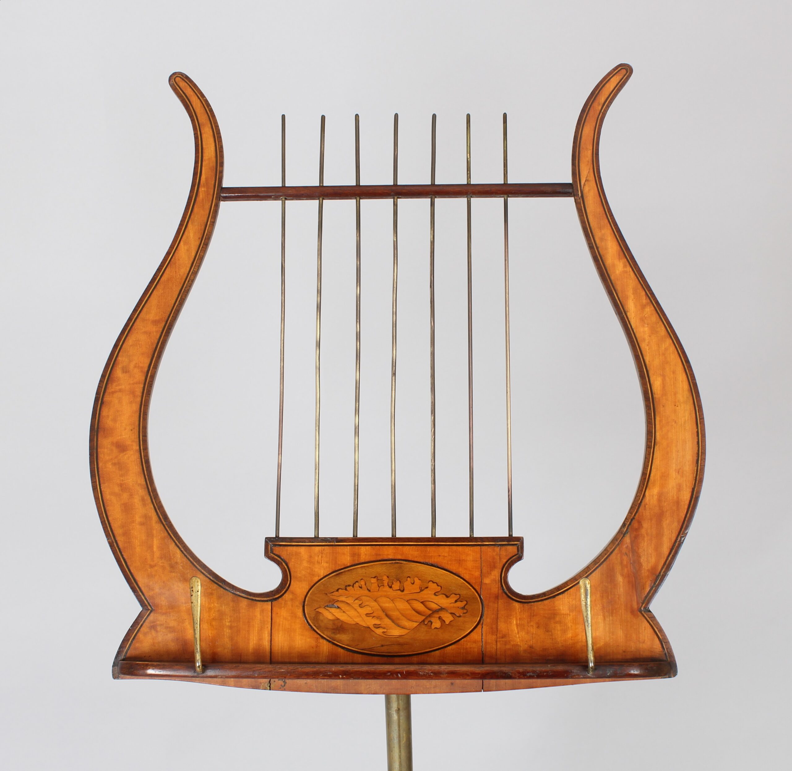 A late 19th century satinwood music-stand in the Sheraton style