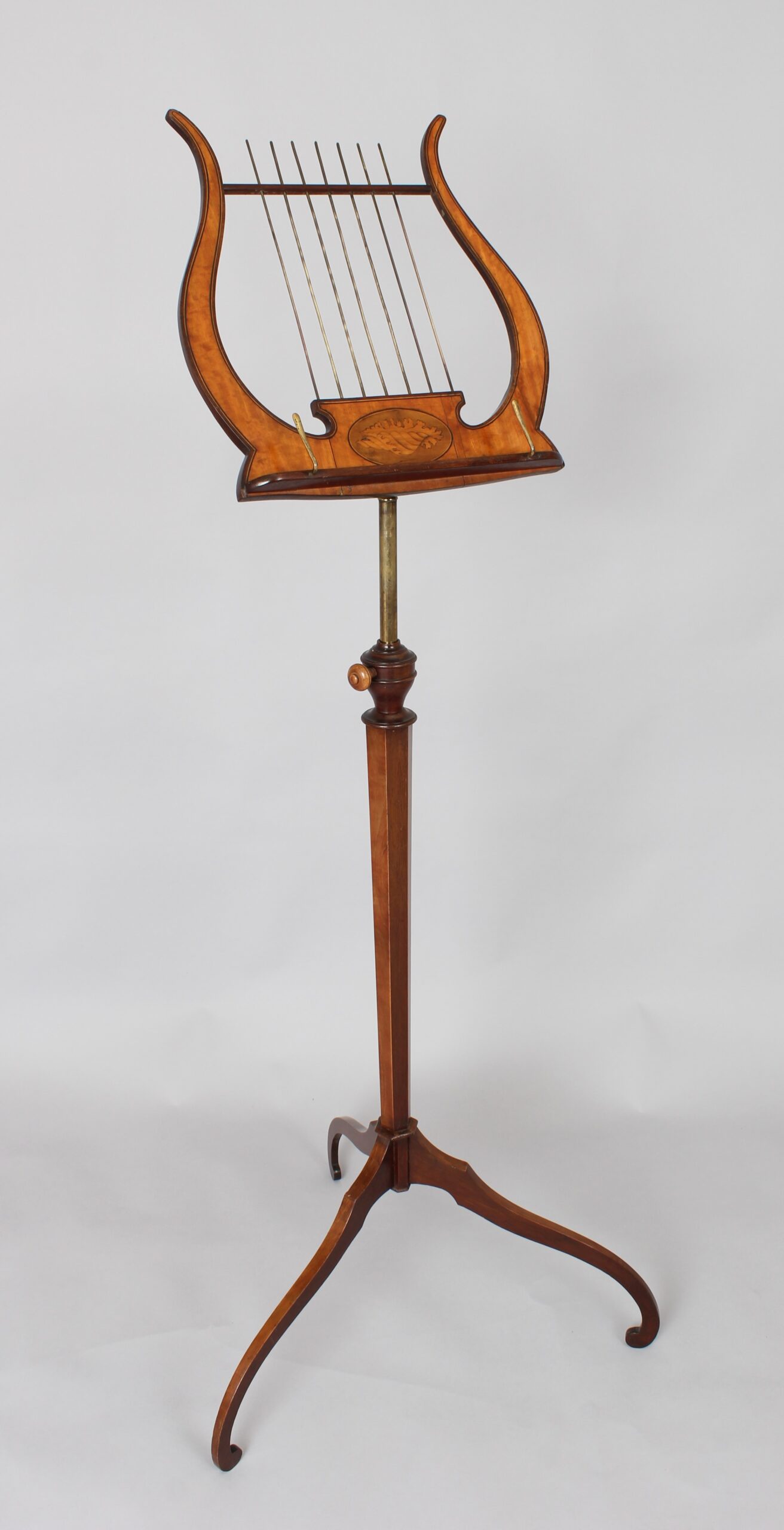 A late 19th century satinwood music-stand in the Sheraton style