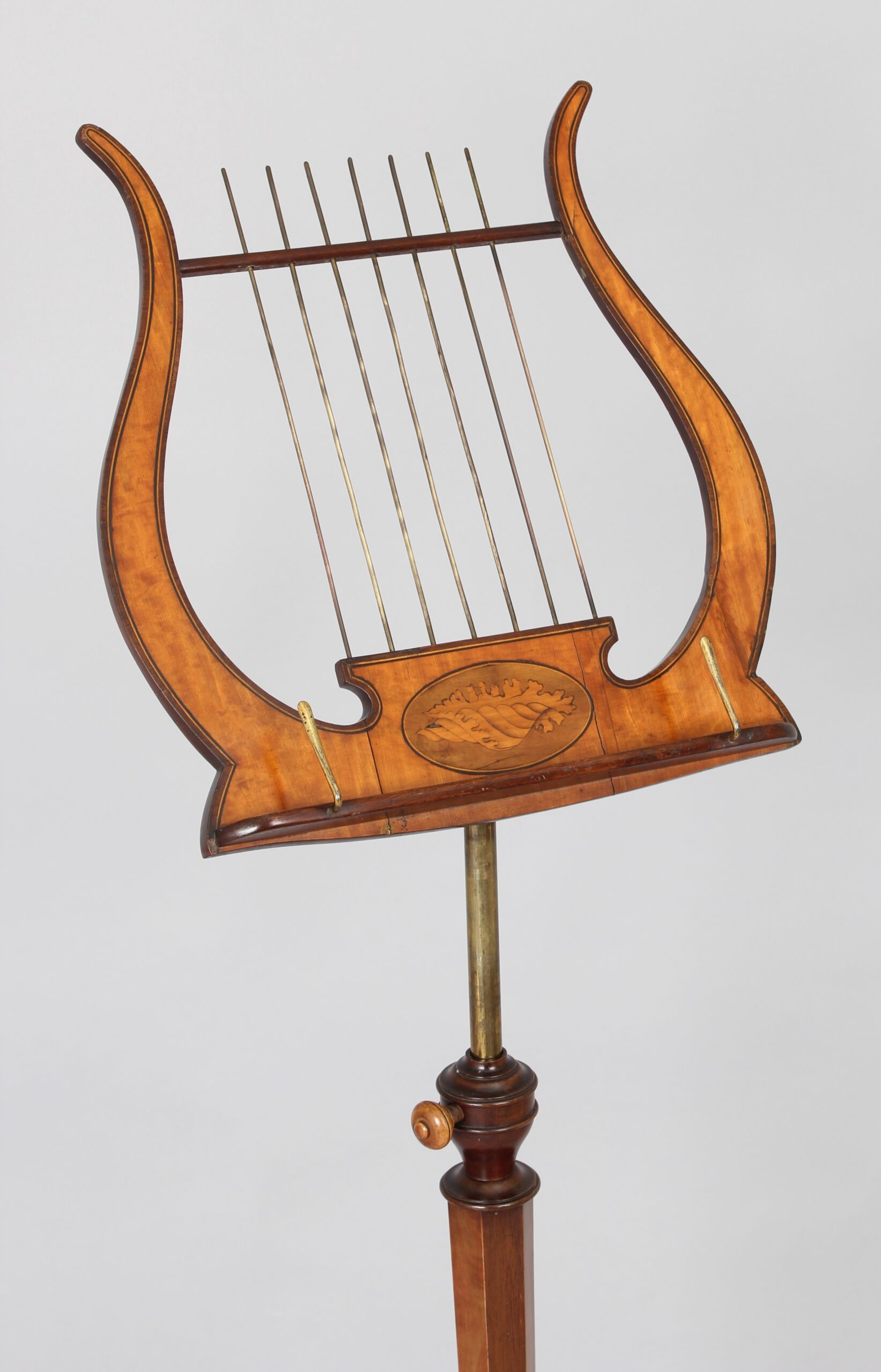 A late 19th century satinwood music-stand in the Sheraton style