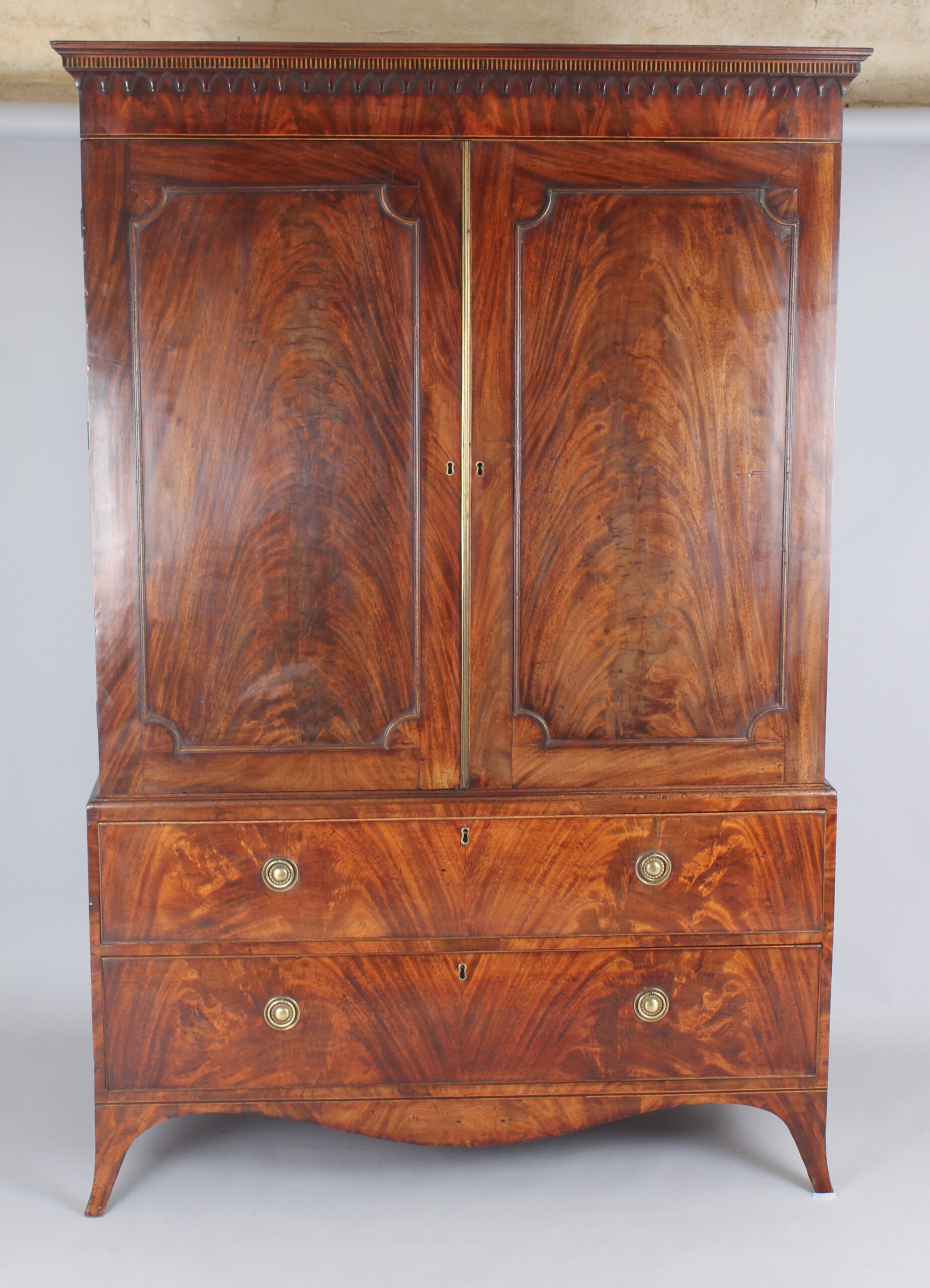 A fine and small George III mahogany linen press