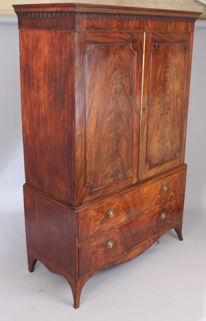 A fine and small George III mahogany linen press