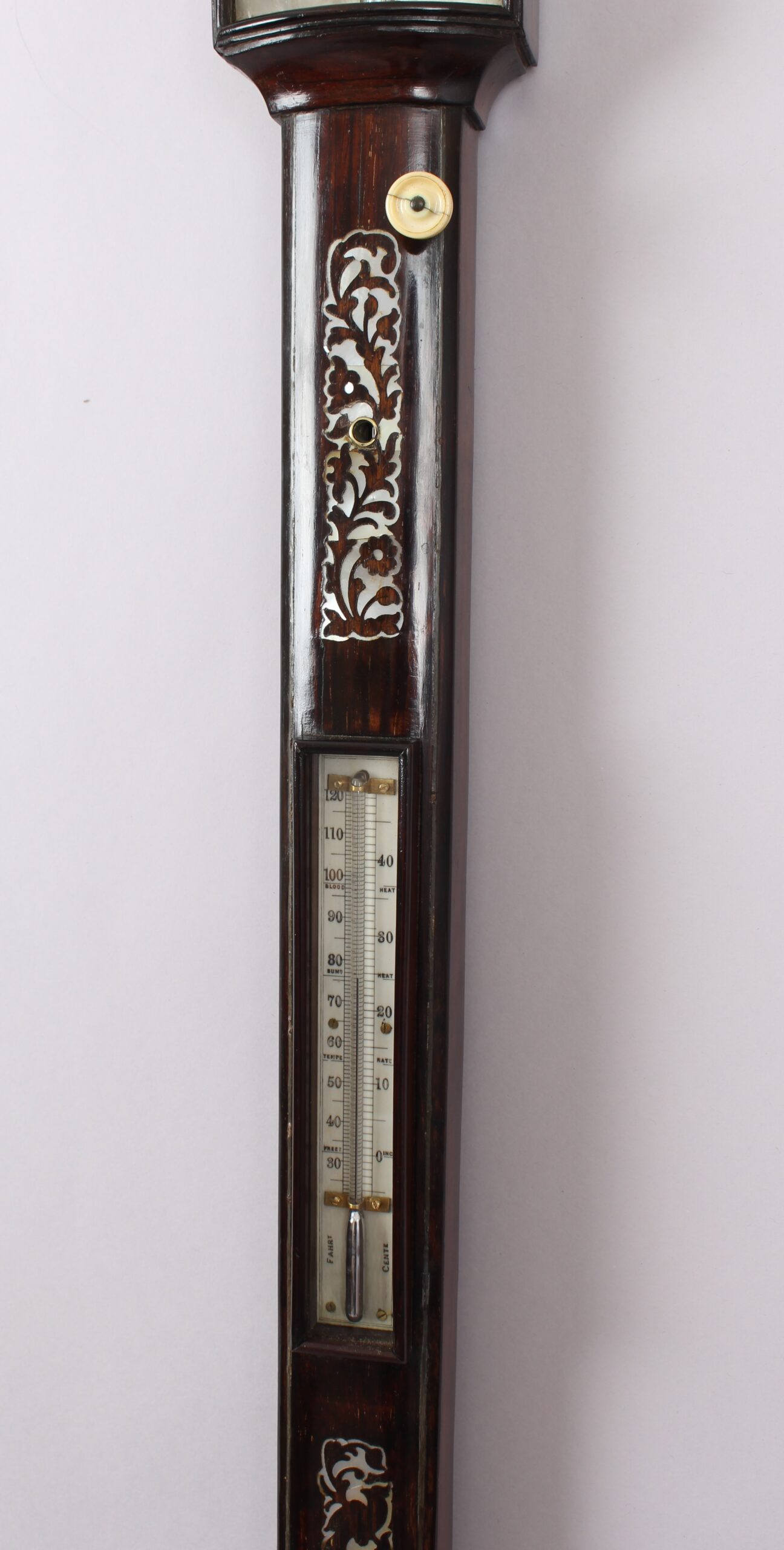 A bow-fronted marine barometer in a well-figured rosewood case