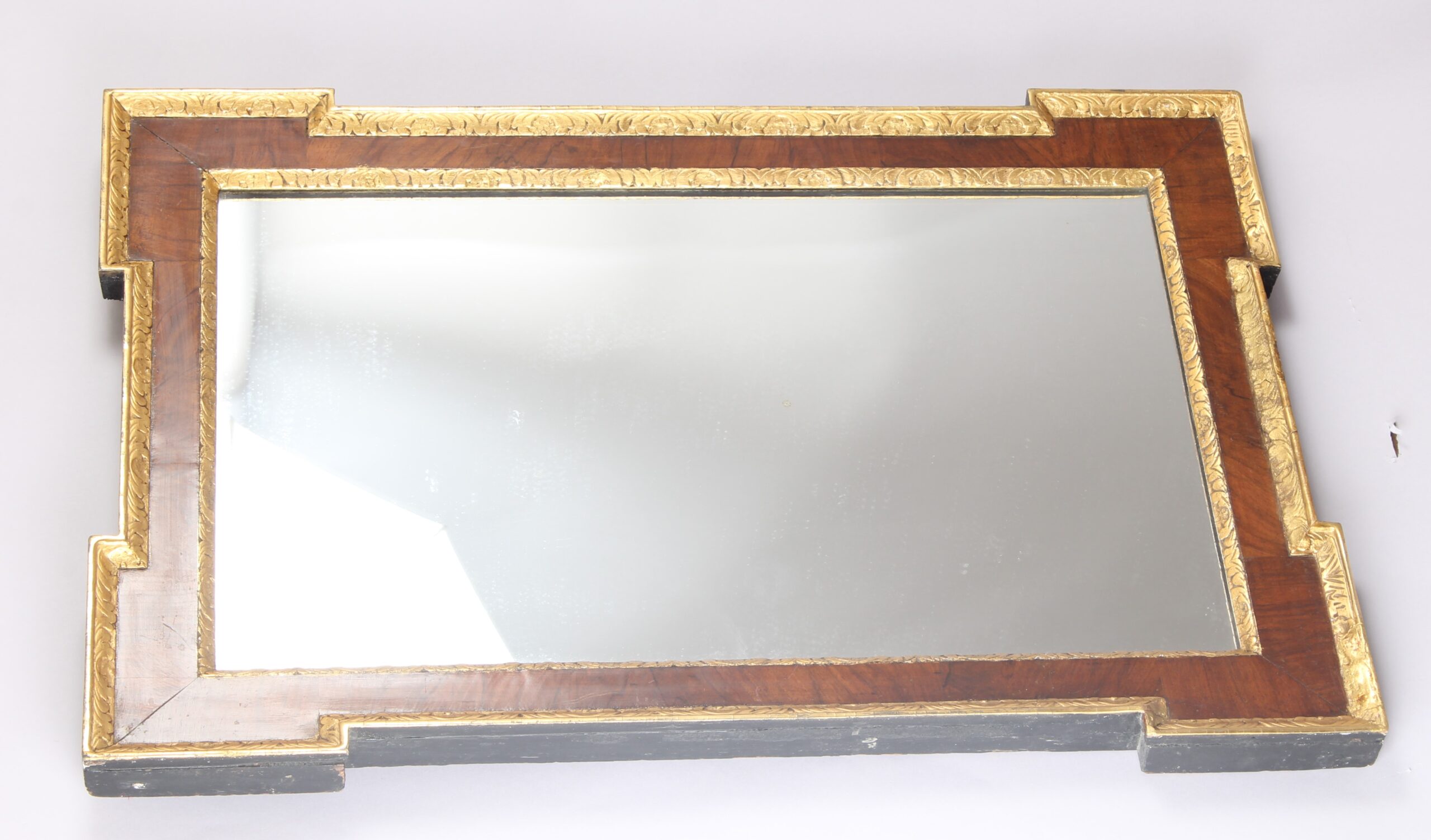An 18th century walnut and gilt slip rectangular mirror