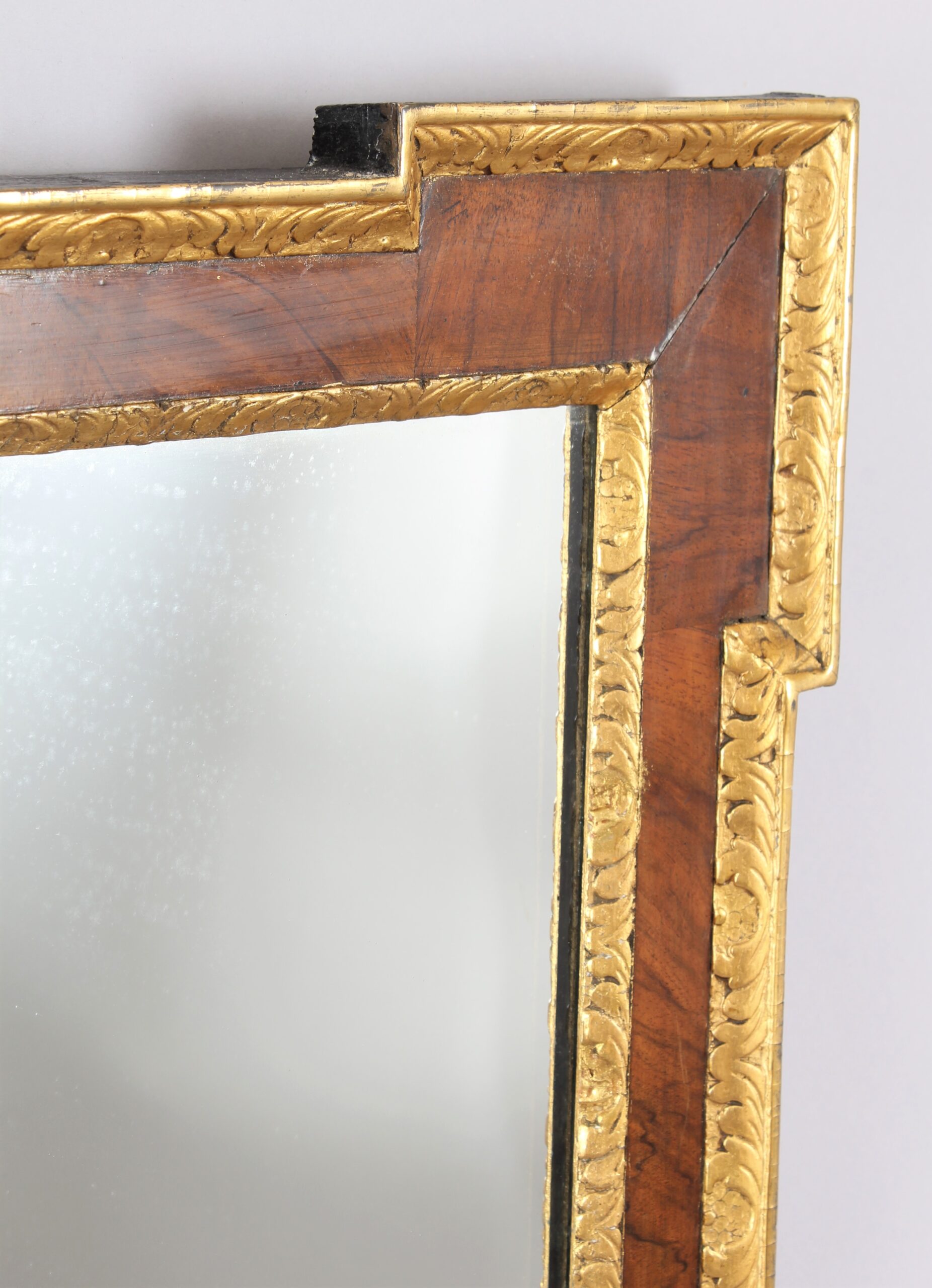 An 18th century walnut and gilt slip rectangular mirror