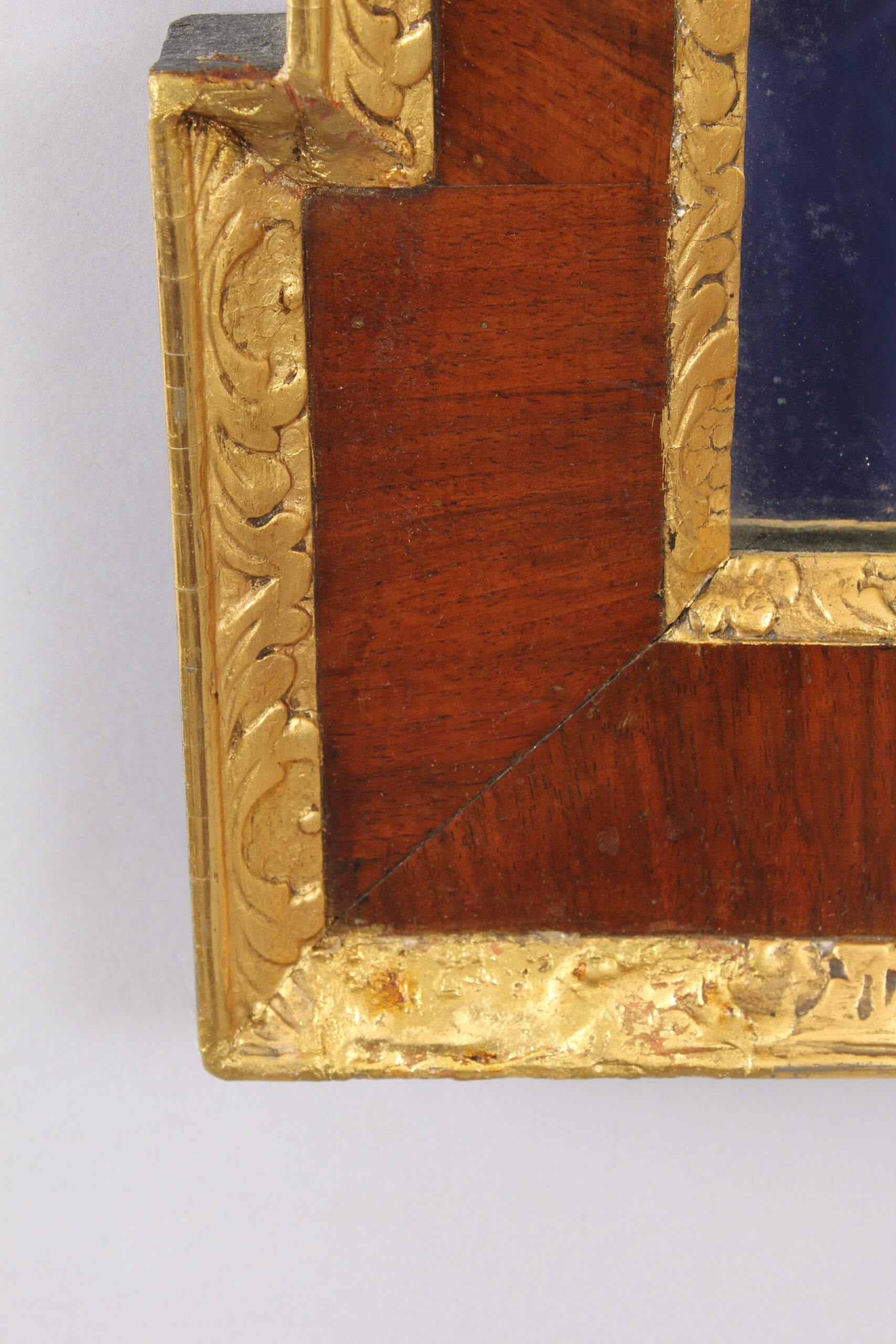 An 18th century walnut and gilt slip rectangular mirror