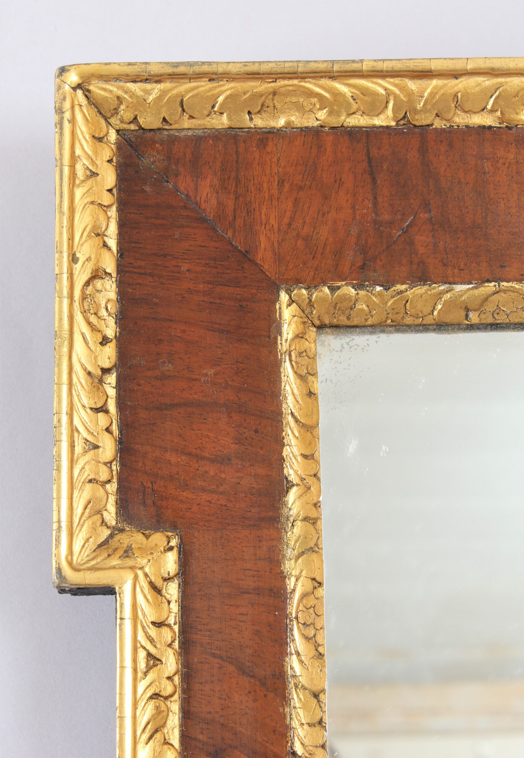 An 18th century walnut and gilt slip rectangular mirror