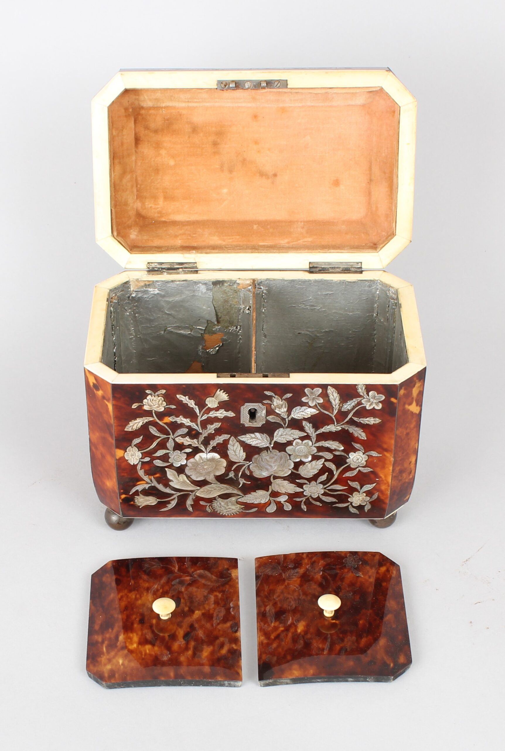A fine WIV period casket shaped well figured tortoiseshell and engraved mother of pearl inlaid tea caddy