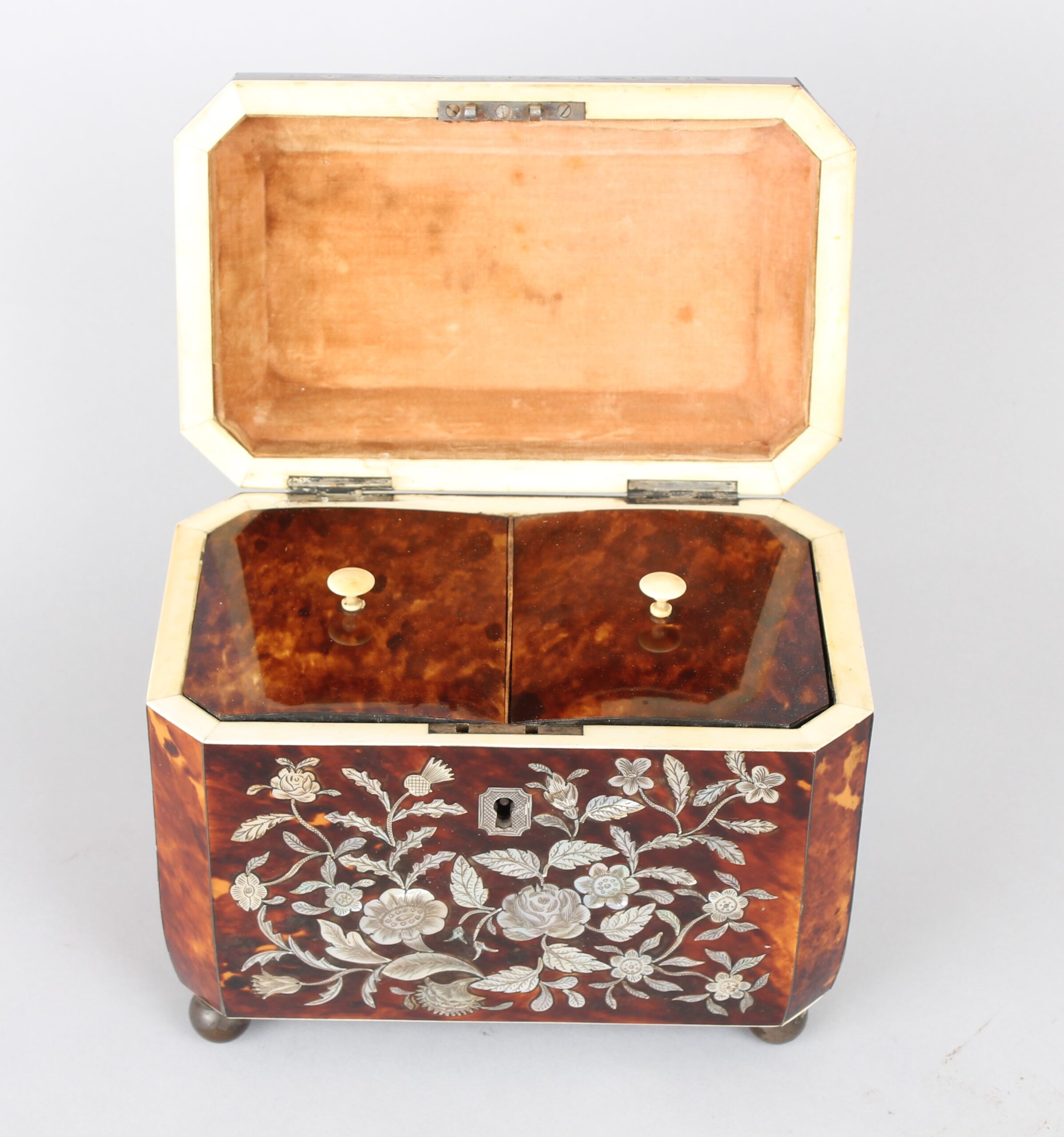 A fine WIV period casket shaped well figured tortoiseshell and engraved mother of pearl inlaid tea caddy