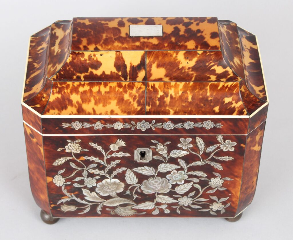 A fine WIV period casket shaped well figured tortoiseshell and engraved mother of pearl inlaid tea caddy