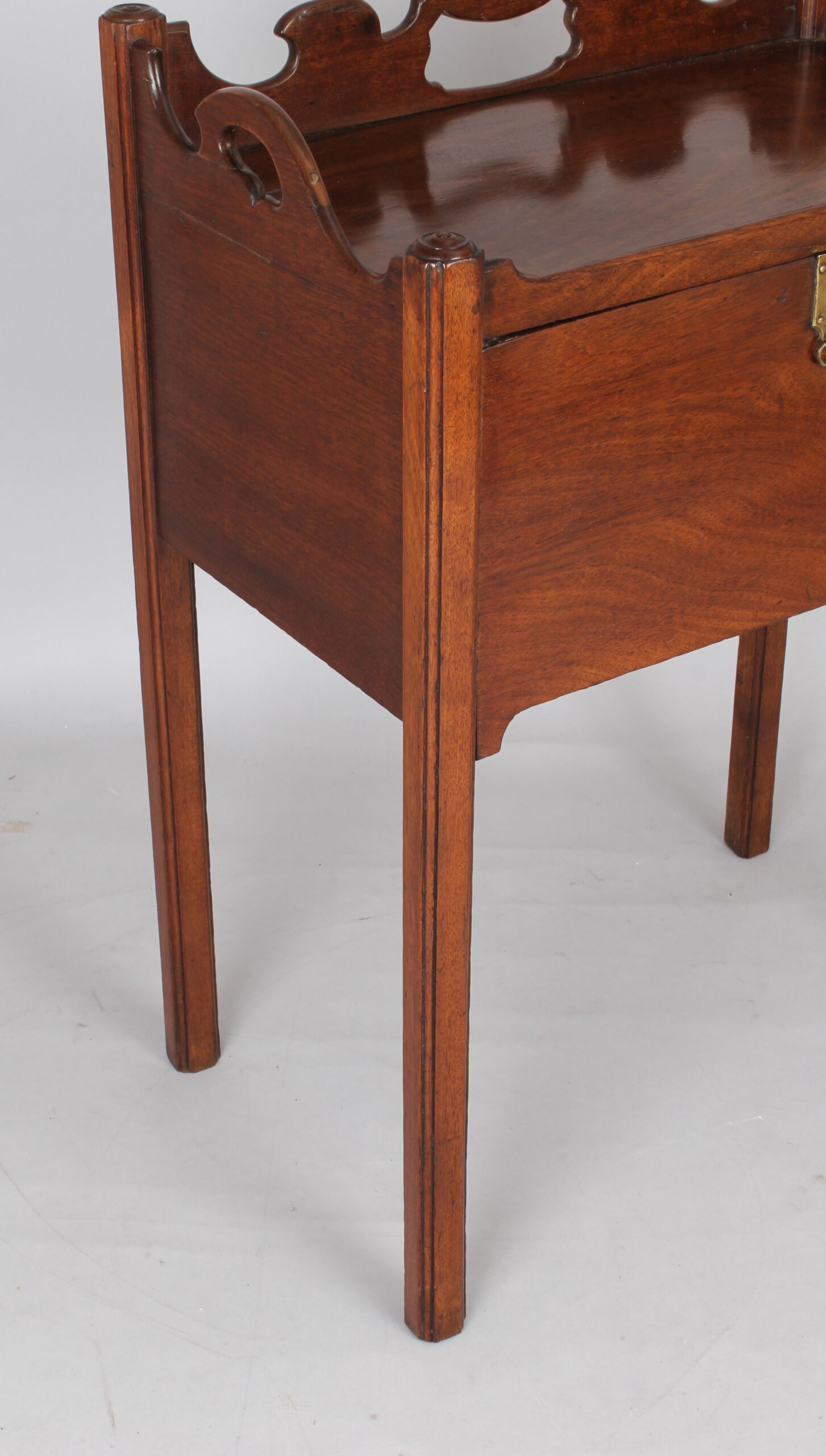 An unusual George III period mahogany night table