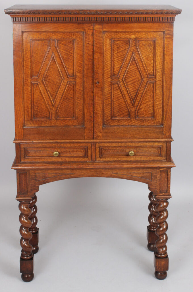 An Edwardian oak stationery cabinet