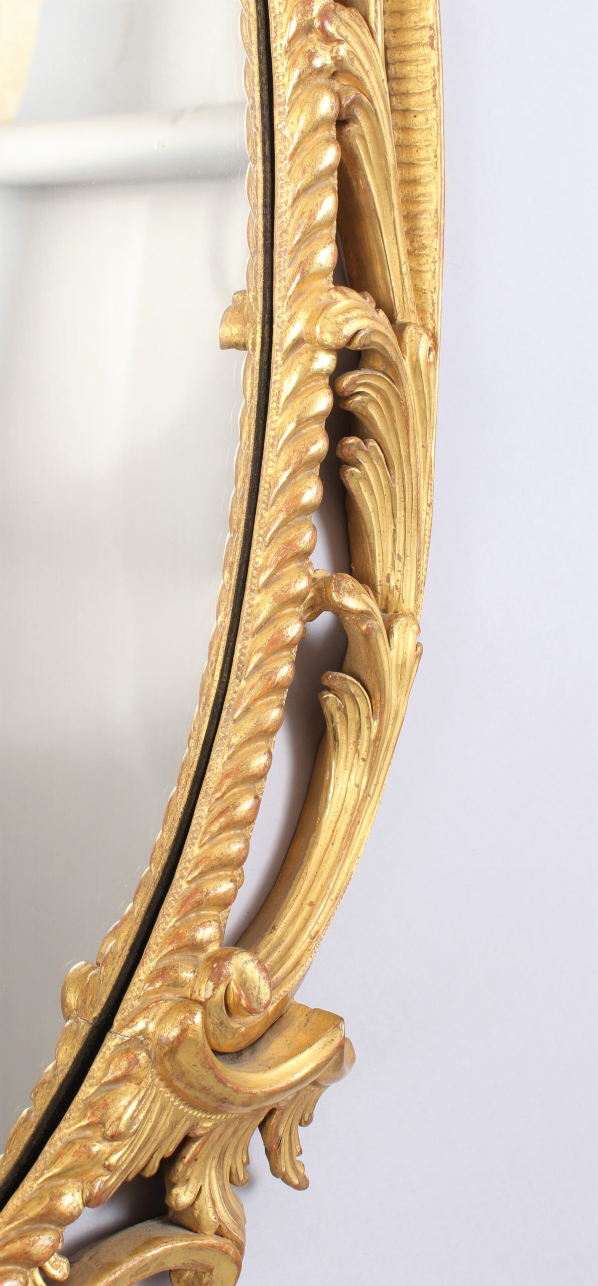 Oval carved and gilt wood mirror