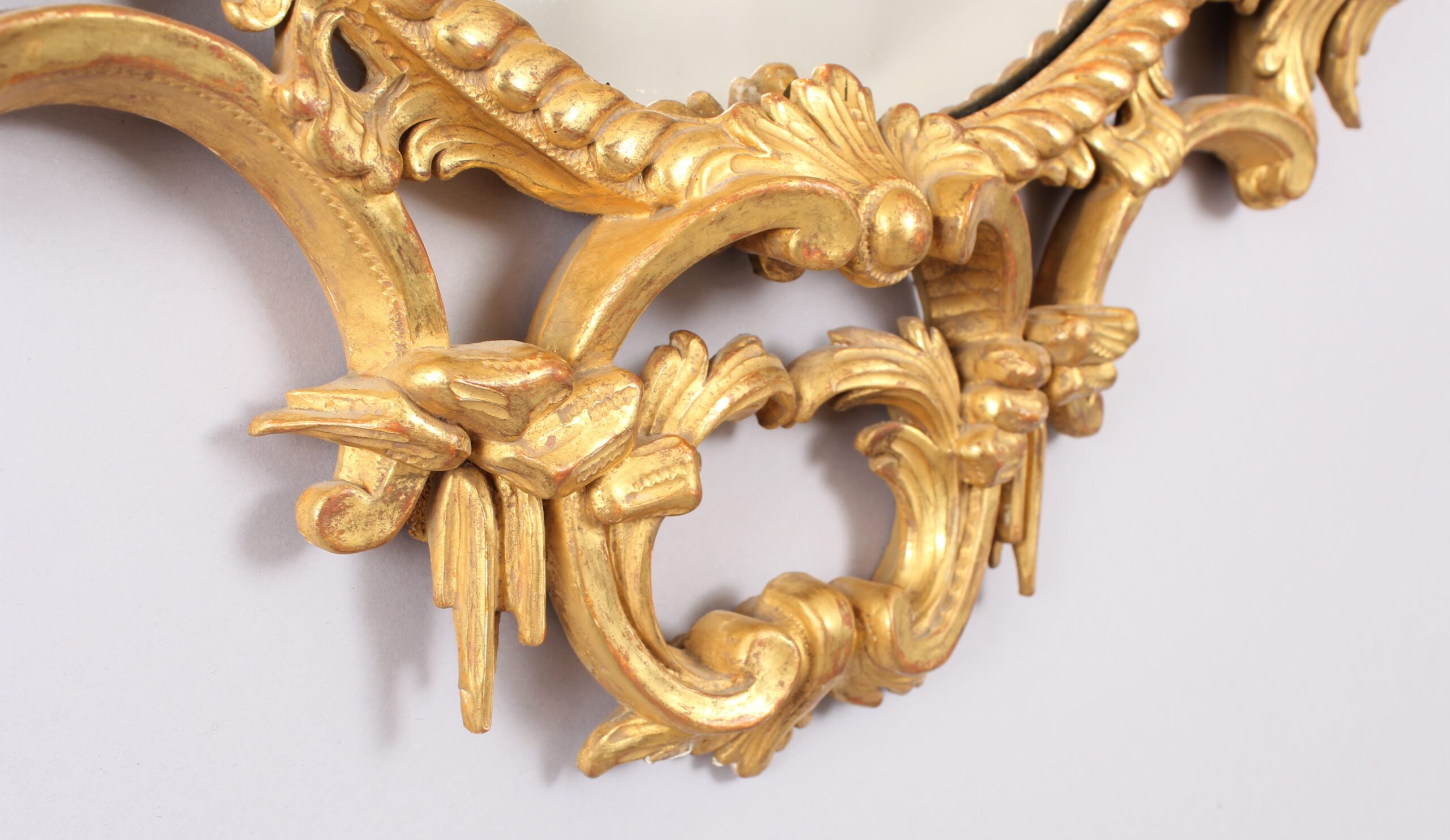 Oval carved and gilt wood mirror