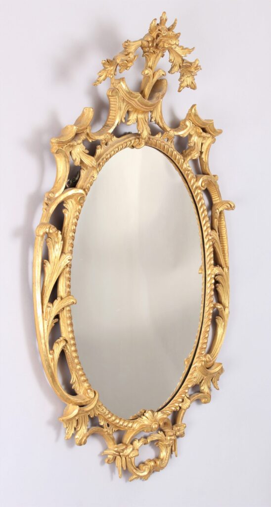 Oval carved and gilt wood mirror