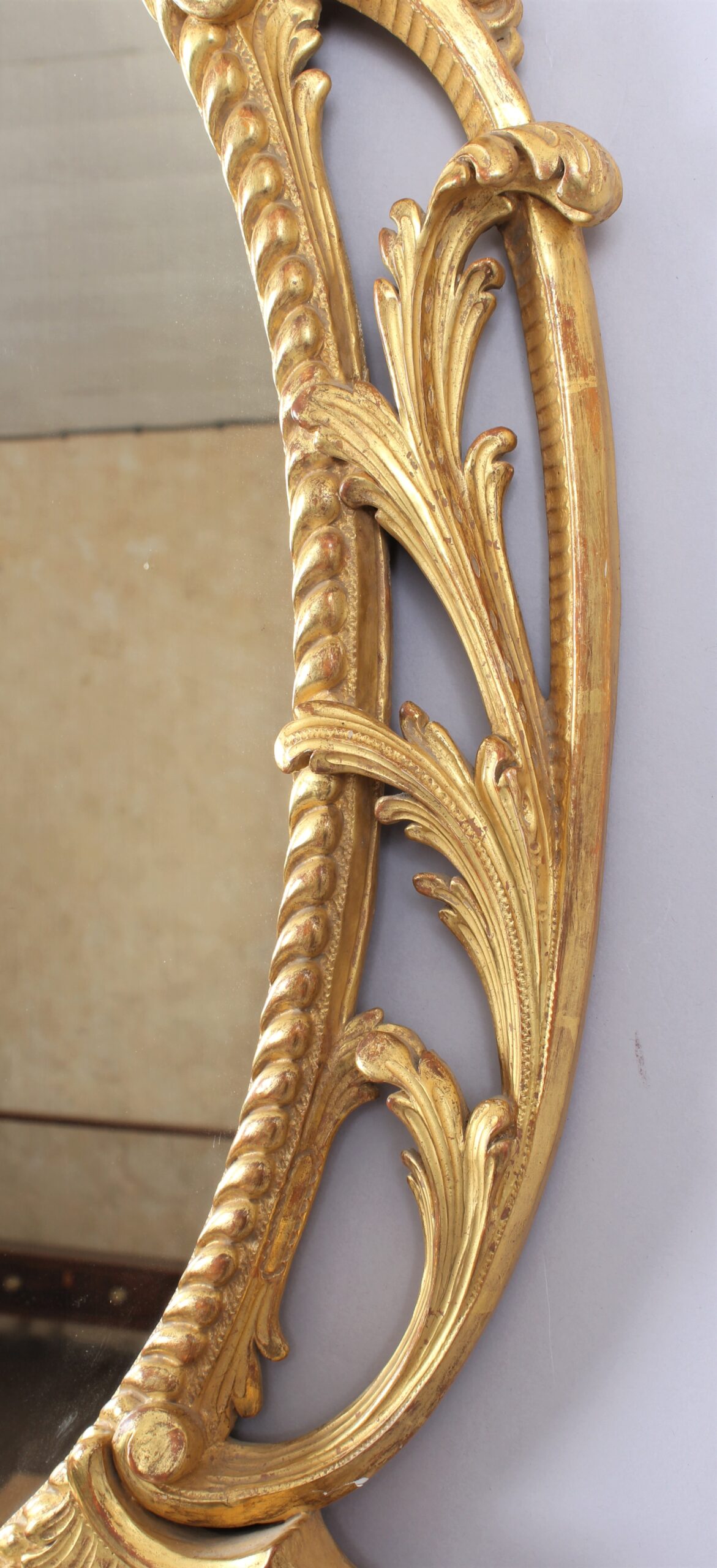Oval carved and gilt wood mirror