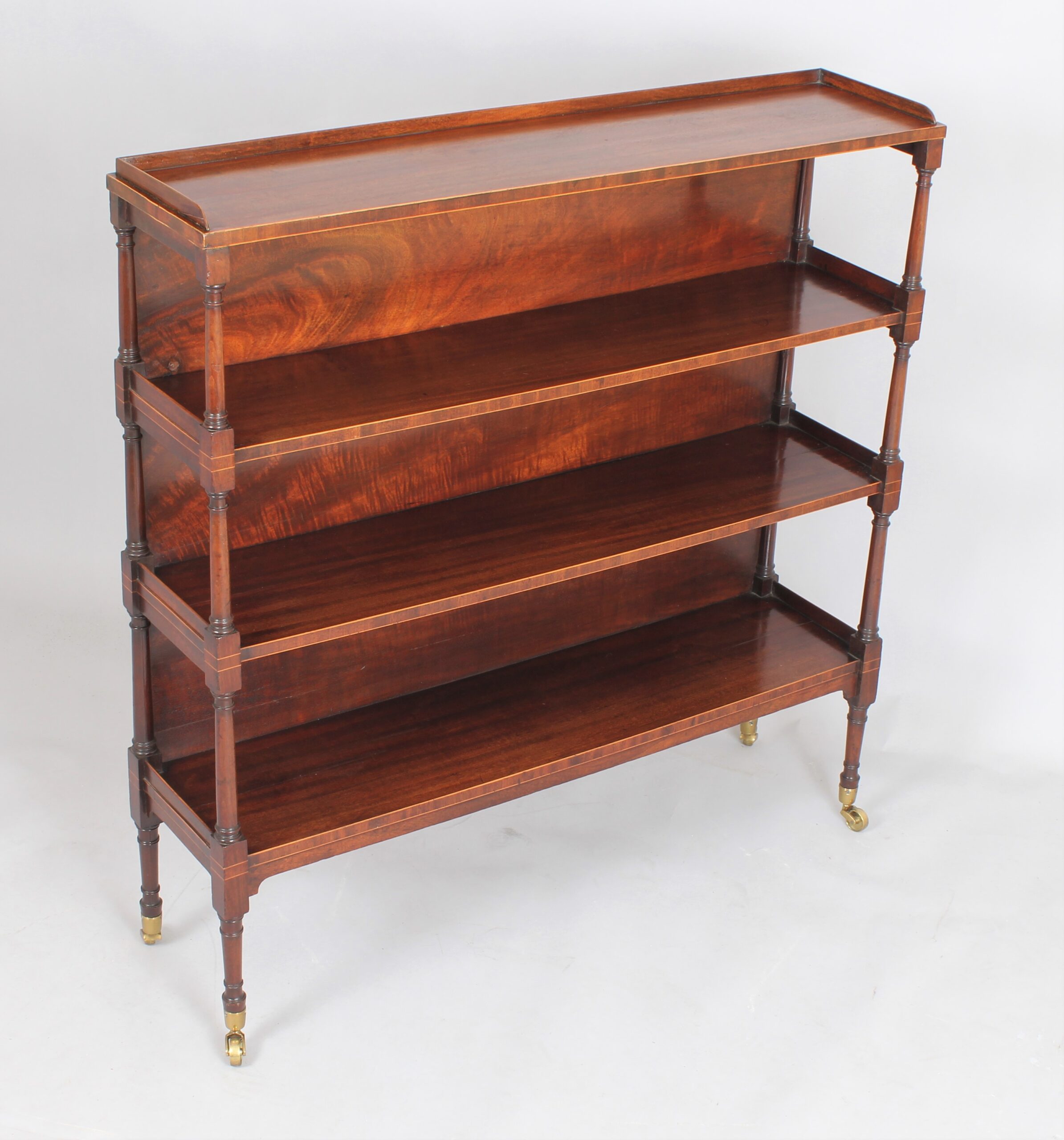 Fine George III mahogany and boxwood strung four tier open shelves
