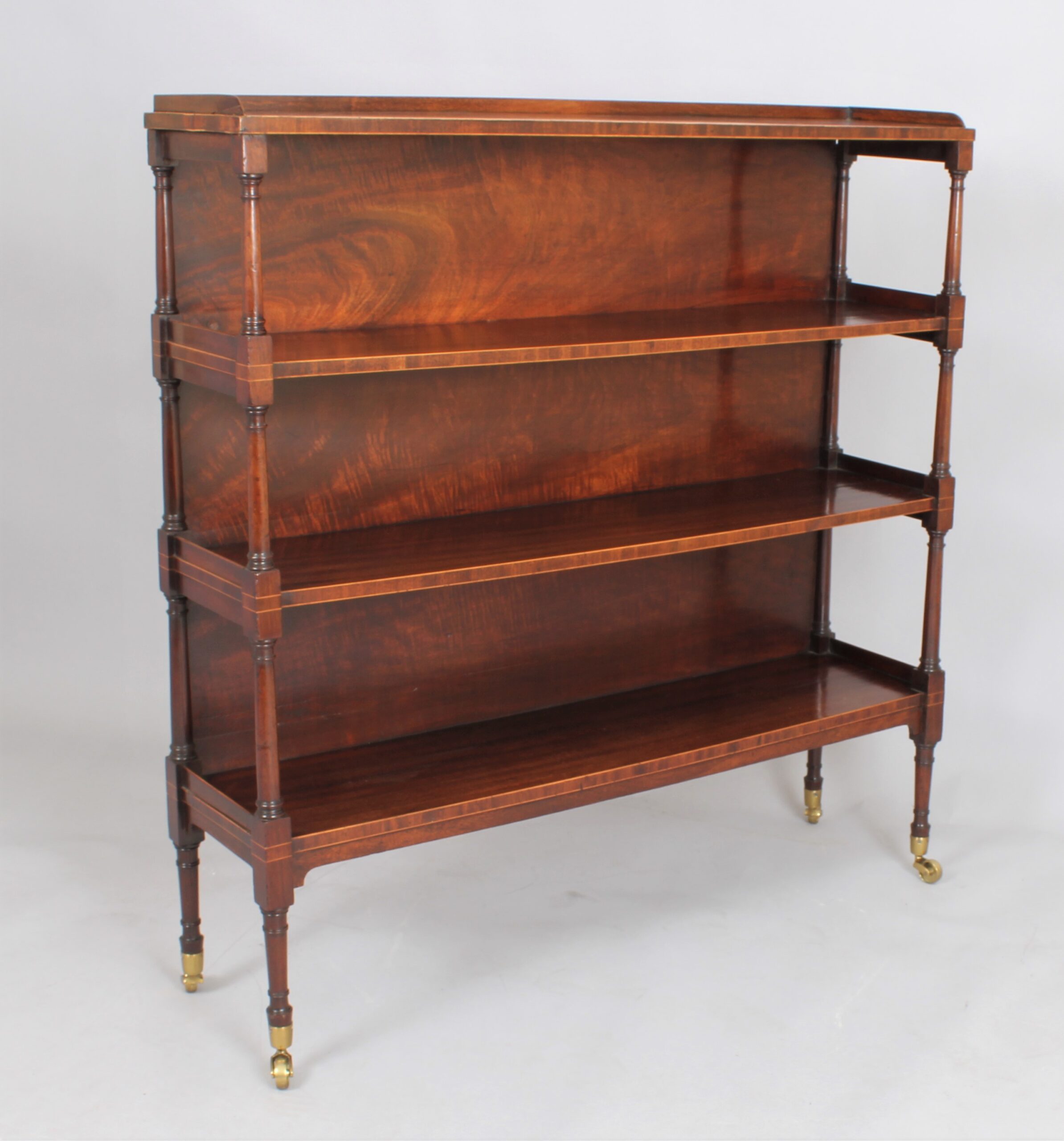 Fine George III mahogany and boxwood strung four tier open shelves