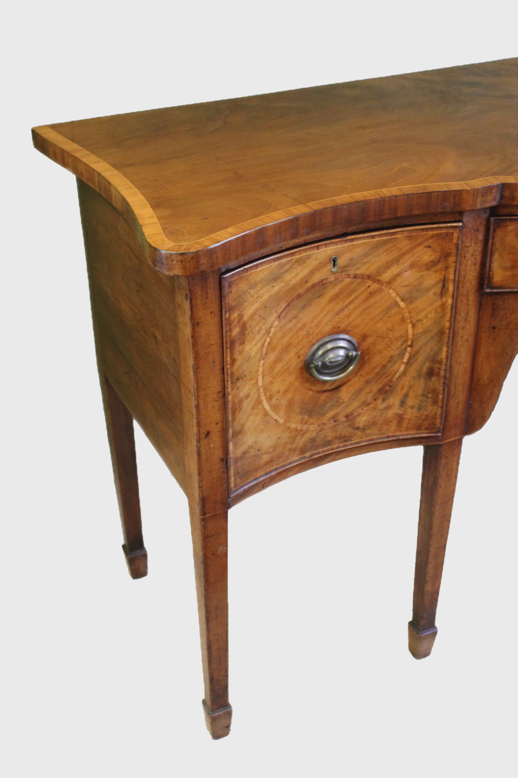 A Hepplewhite period mahogany serpentine fronted sideboard of delightfully small proportions