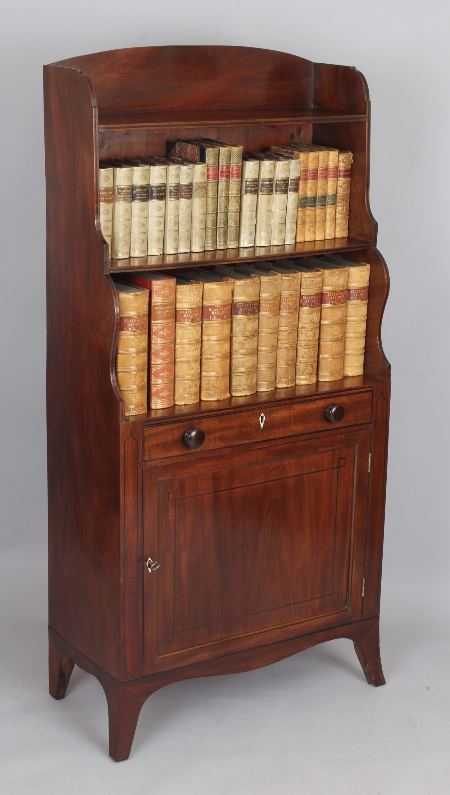 George III period mahogany cupboard base water fall bookshelves