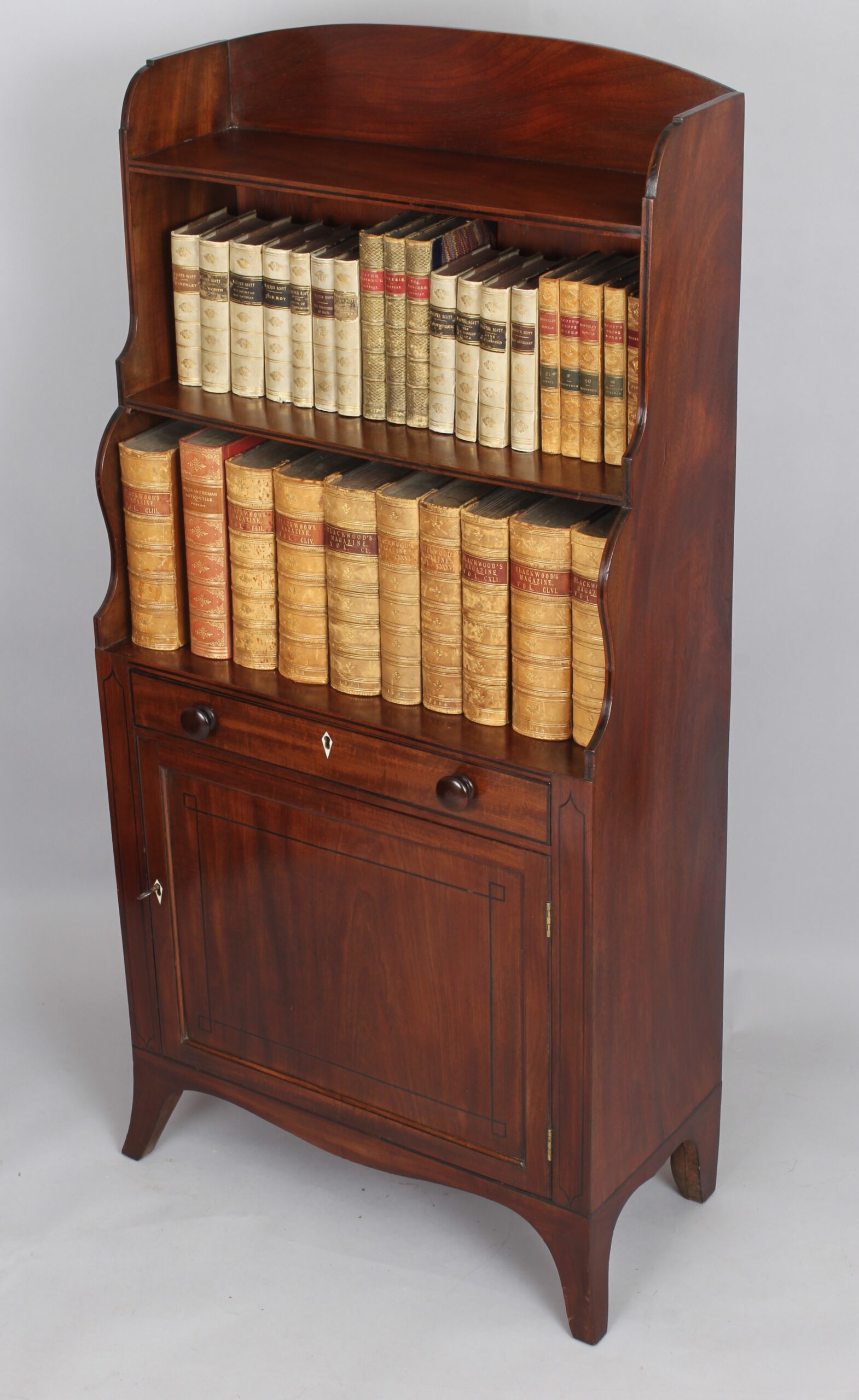 George III period mahogany cupboard base water fall bookshelves